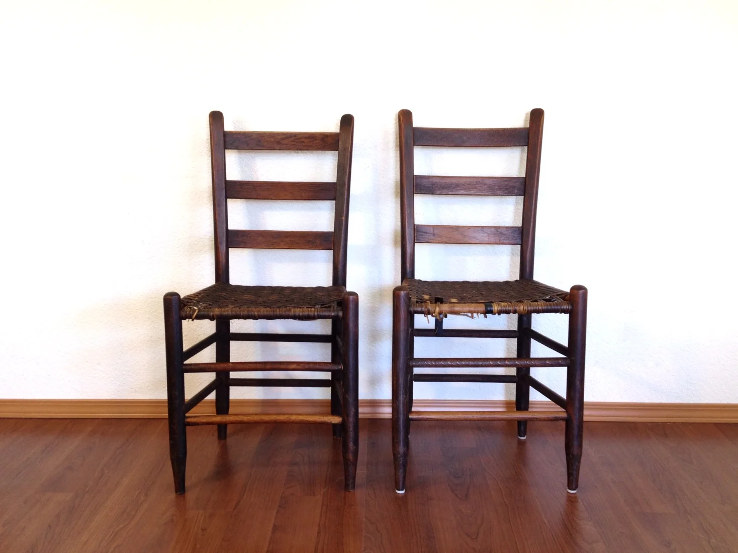 pair of primitive reed seat chairs.