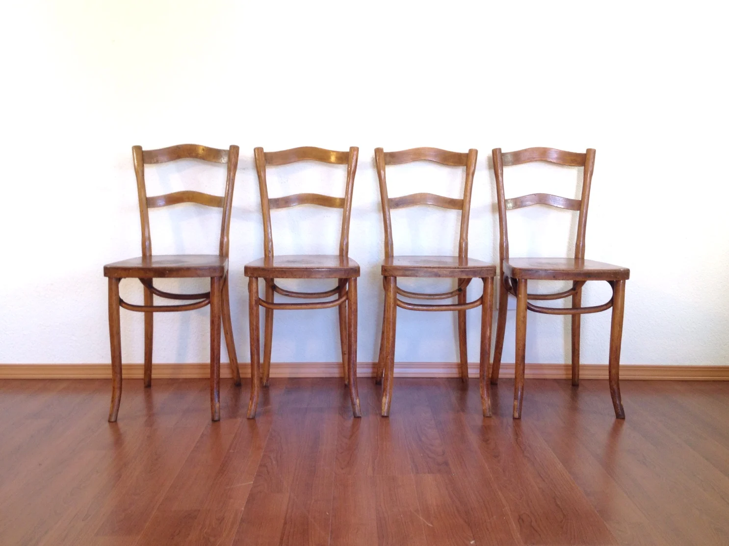 set of 4 primitive bent wood chairs.