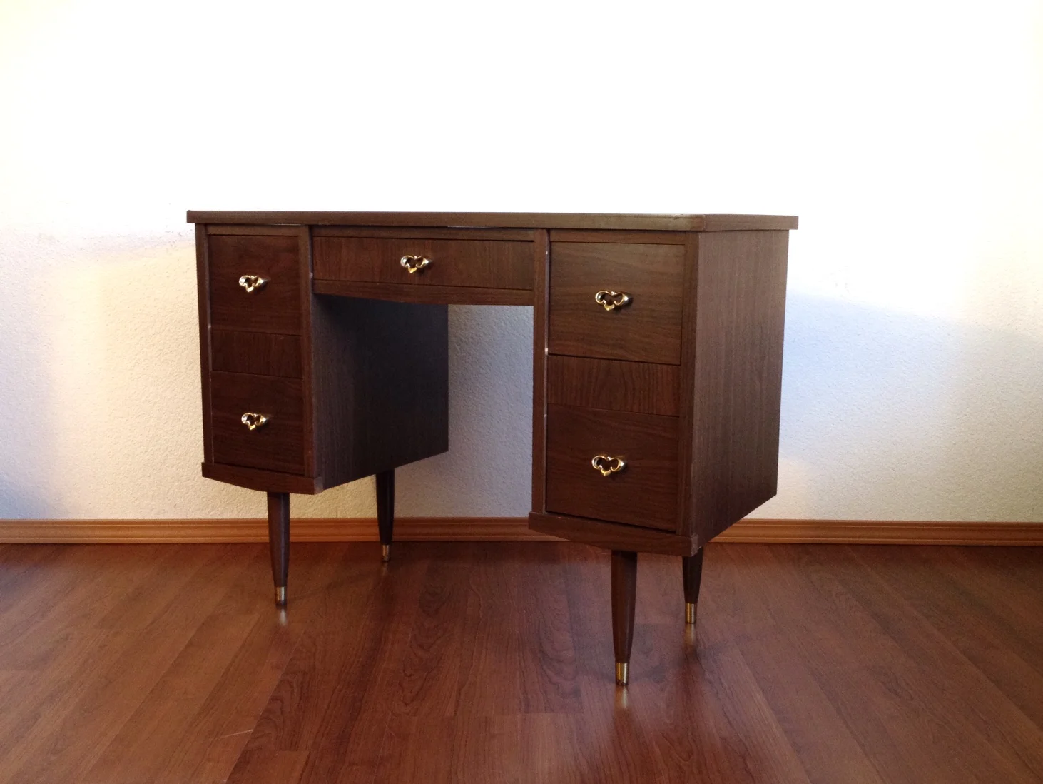 vintage mid century desk with brass accents.