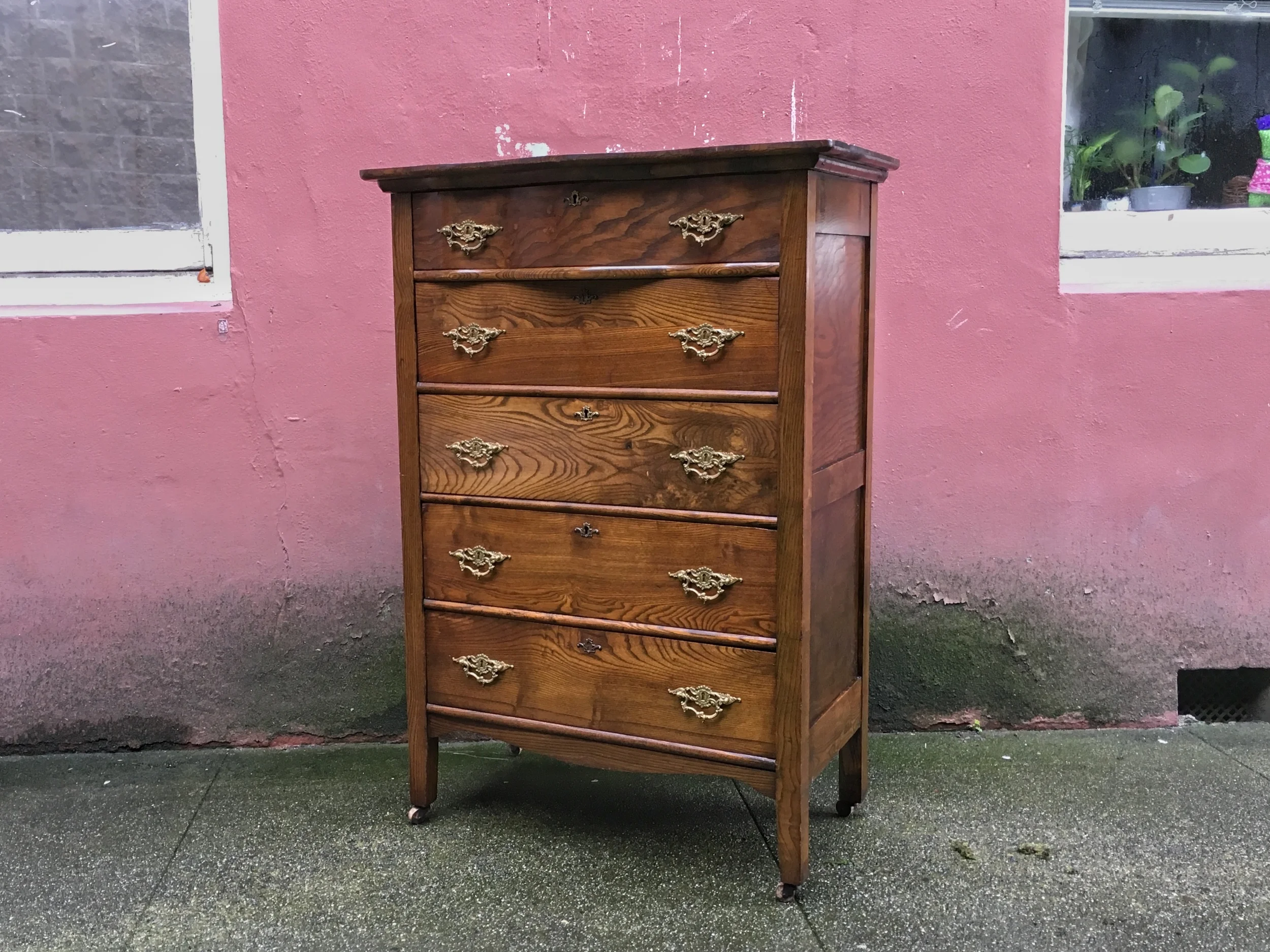 Antique highboy dresser with serpentine top drawer.