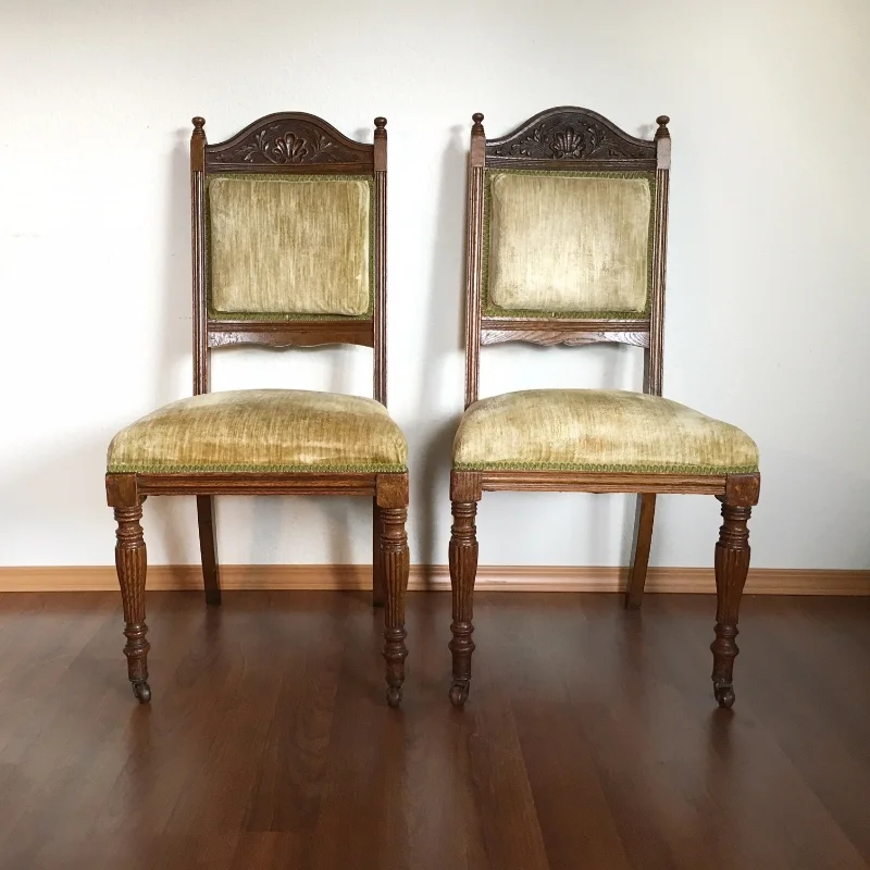 pair of antique Eastlake chairs with green velvet upholstery.