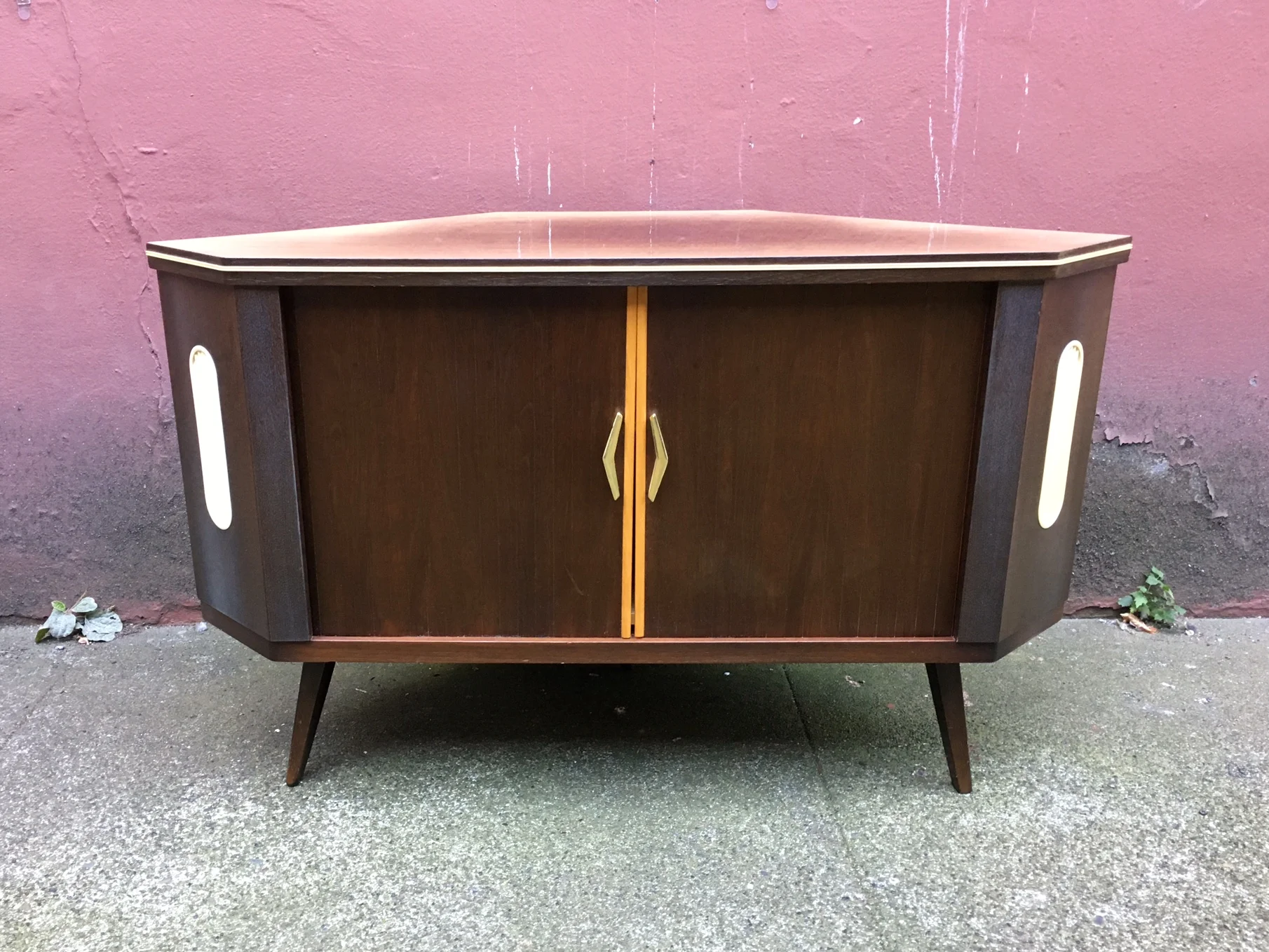 vintage mid century modern corner bar with rotating storage.