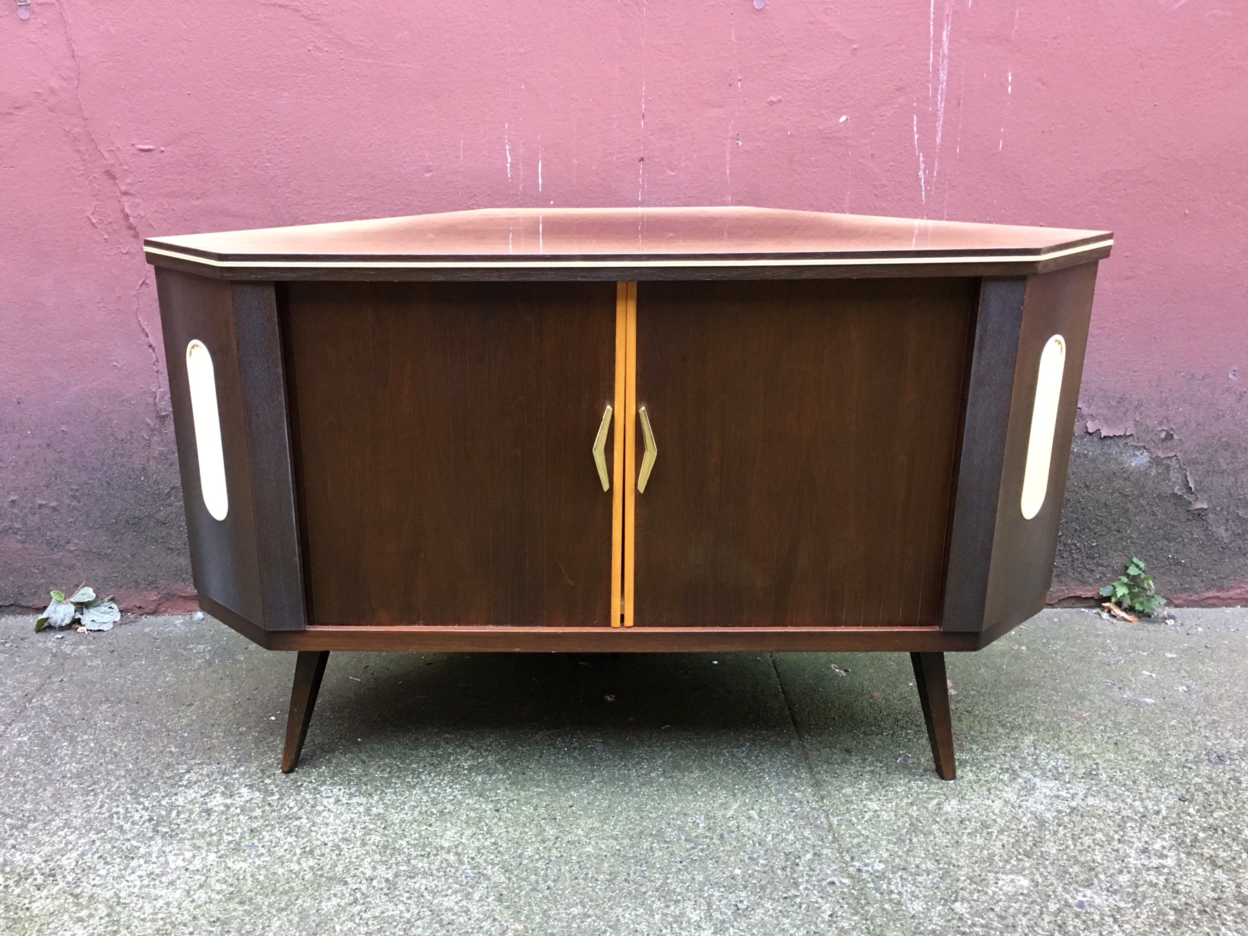 vintage mid century modern corner bar with rotating storage.