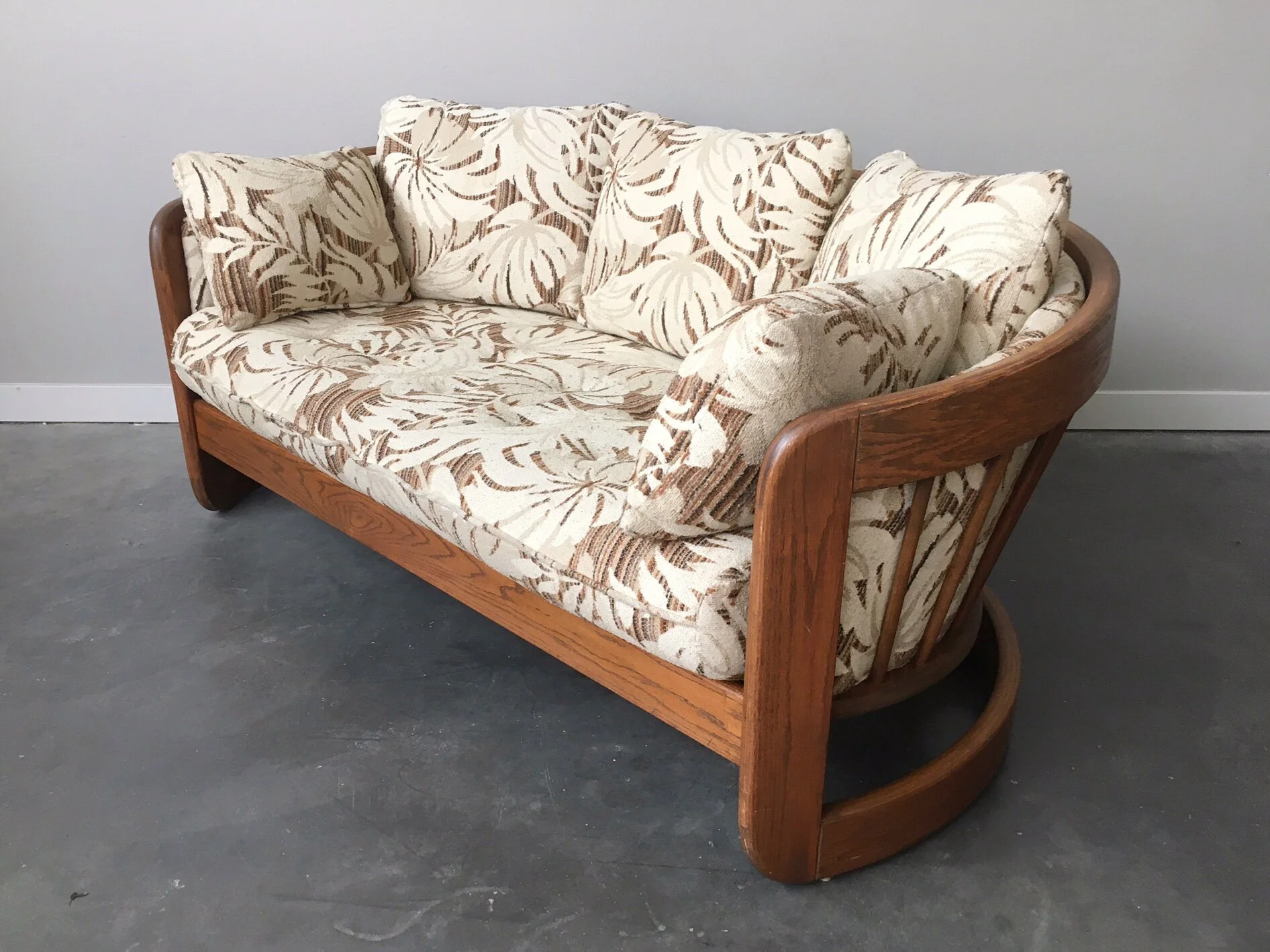 vintage 1970s oak loveseat in monstera print by Howard Furniture