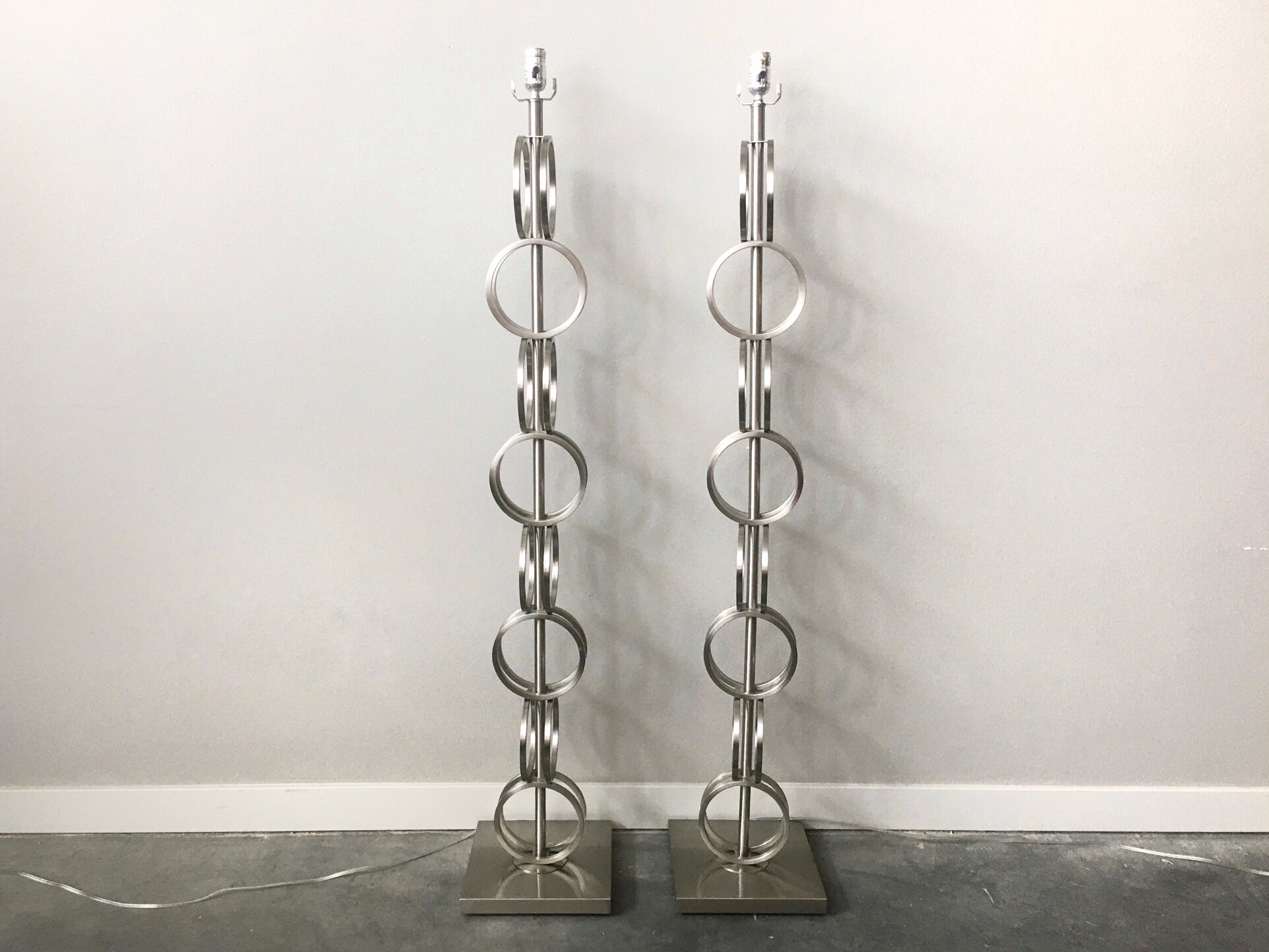 pair of contemporary stacked ring floor lamps