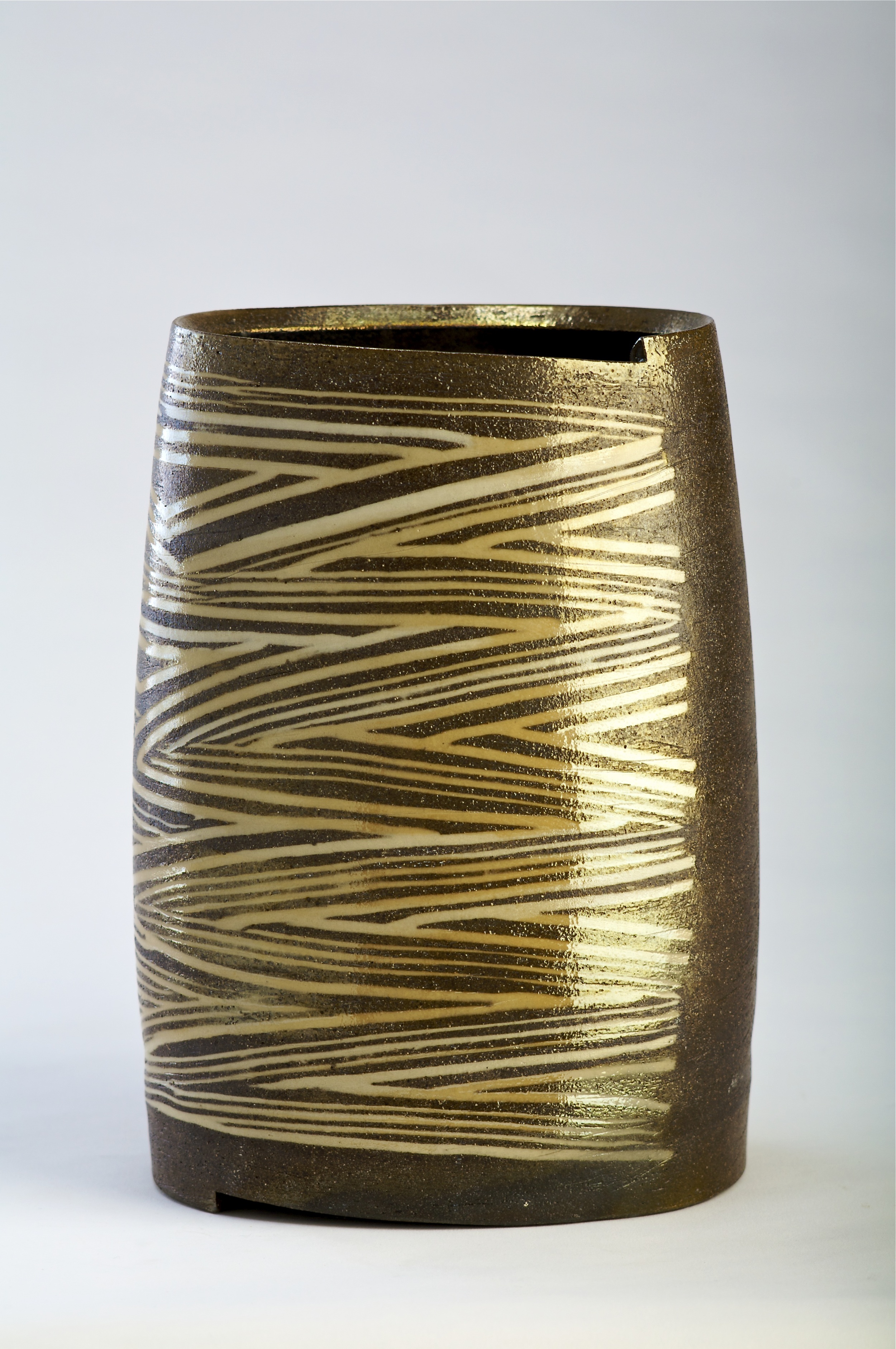  Thrown altered and cut ovoid form.  incised pattern with Inlaid slip.  Sagger fired with charcoal and granite luster glaze  350mm H  2009 