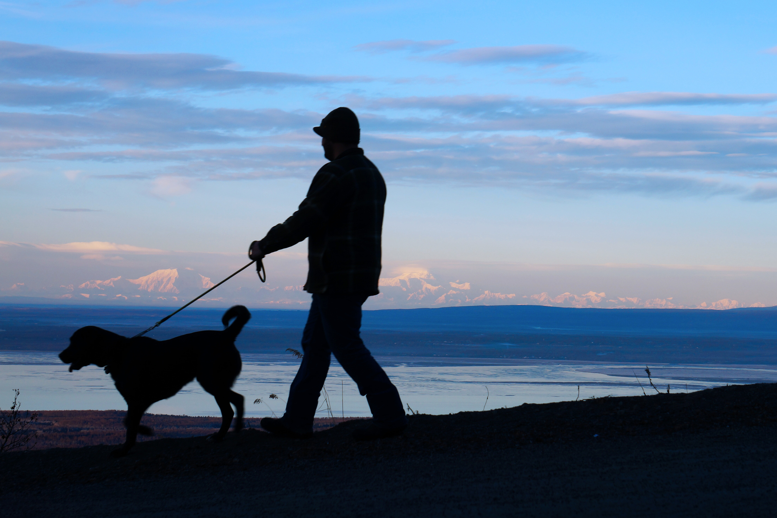 Tony and Ruger silhouetted against the mountains atop Mt. Baldy.