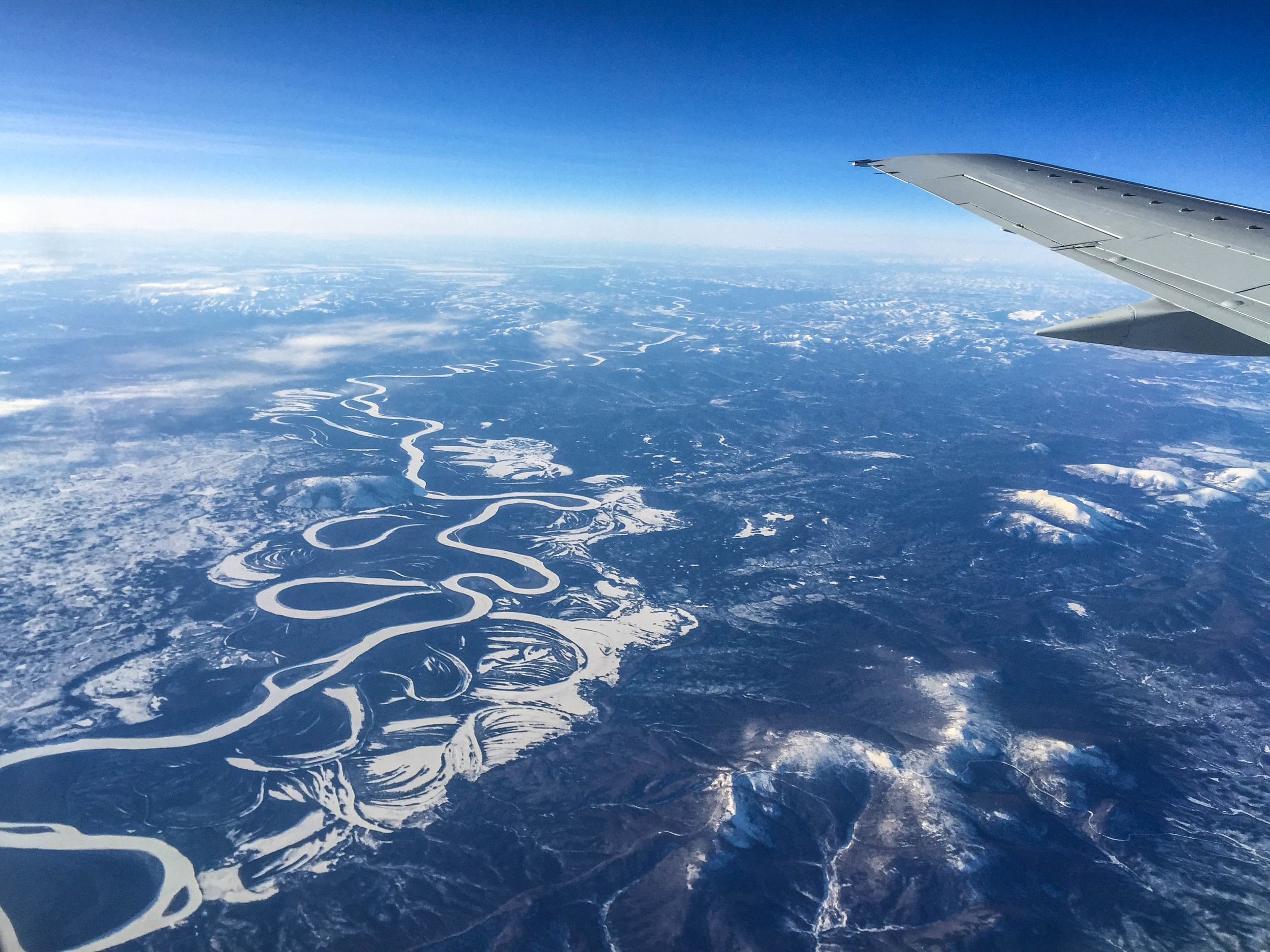 The girl in the seat next to me asks the flight attendant for a fruit and cheese tray. “Um, we’re going to Nome…” she responds. “We don’t have things like that on this flight.” She hands her a bag of pretzels and moves on, while I continue staring at the sparkling ribbons of frozen rivers below, threading across Alaska.