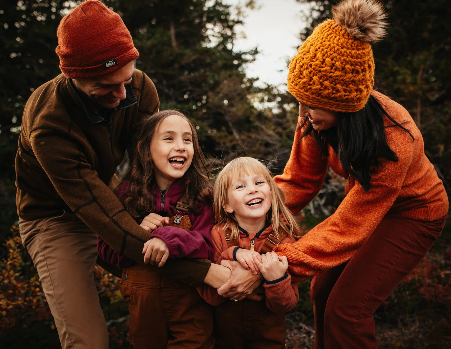 A family laughs together in the fall
