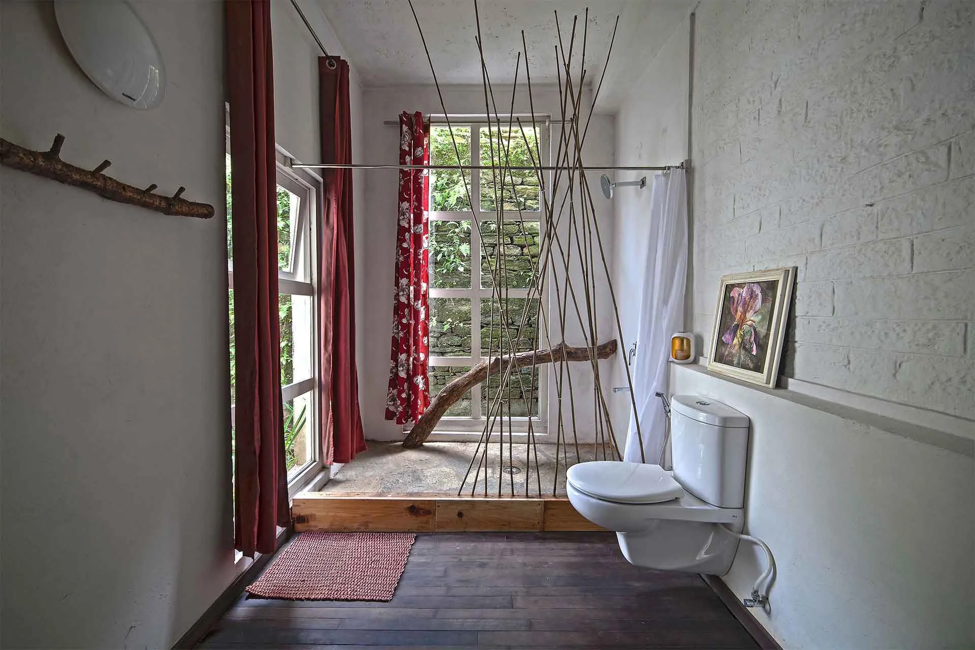 ..a fallen log holding the shower curtain partition - using this bathroom is a joyful experience