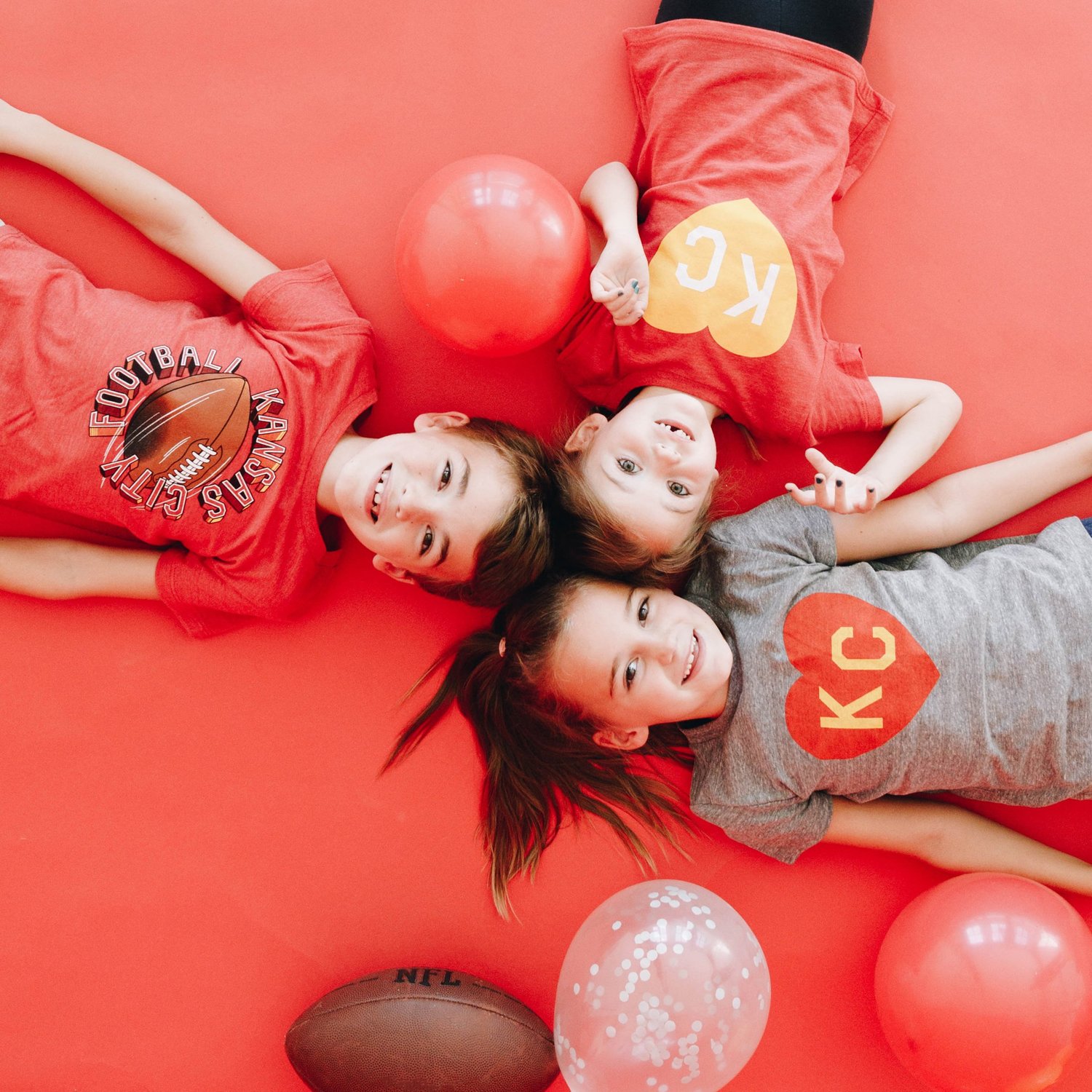 Children wearing Kansas City football shirts in a colorful lifestyle shoot