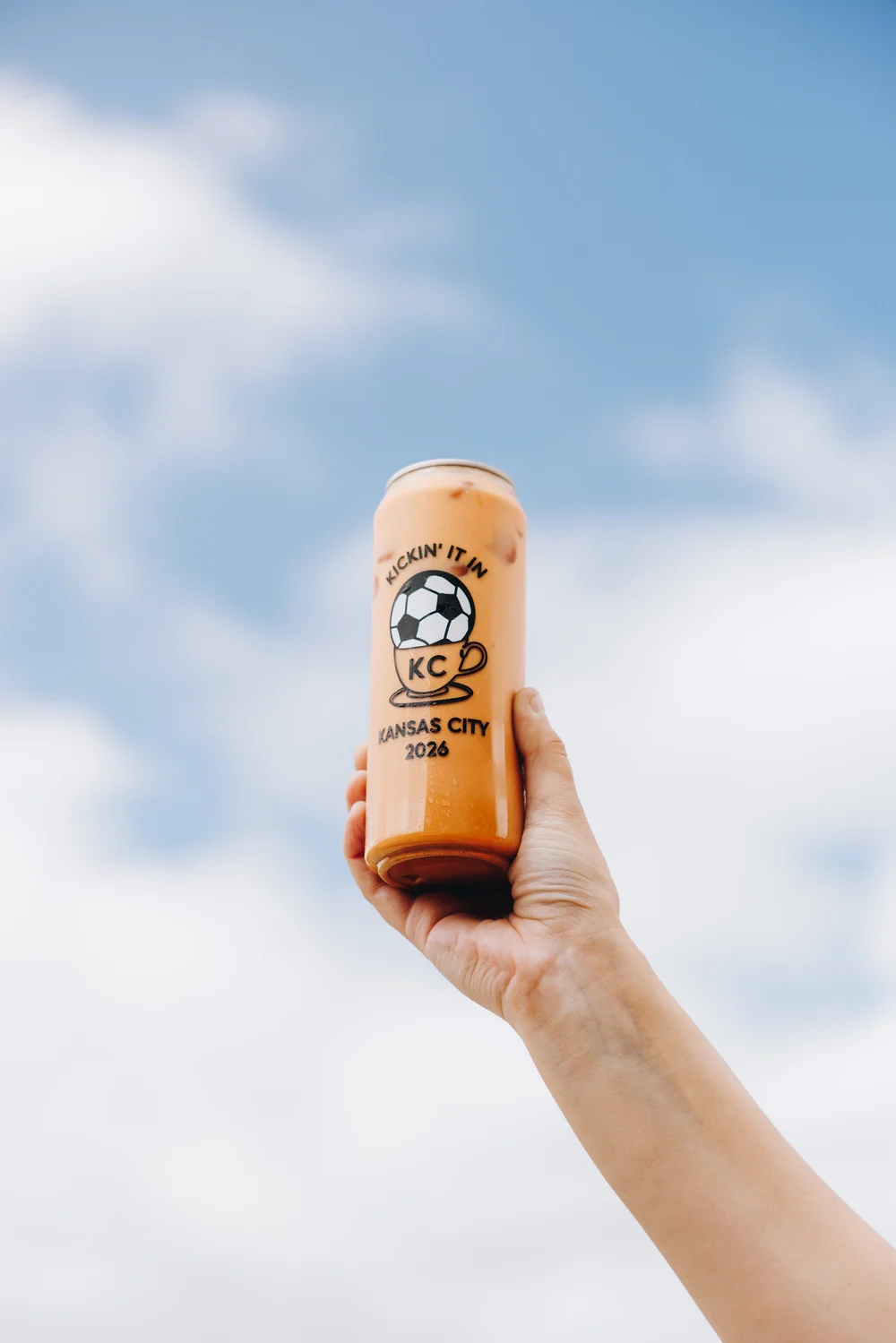 Stroopwafel latte held against a blue sky