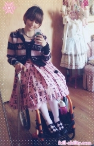 This day, I just stayed home. I would have to watch out for a dangly pom pom like that if I were to go out. Also, when I am actually wheeling, I tuck my dress under my legs to prevent damage. I just position it like that for the picture. ;)