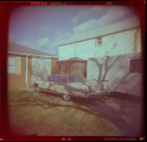 A car, a van, trees, stone facing, what's not to love? -- by Joe Reifer