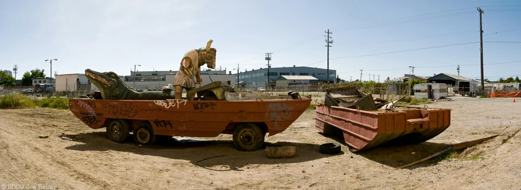 An alligator and a minotaur take a ride in an amphibious vehicle -- by Joe Reifer
