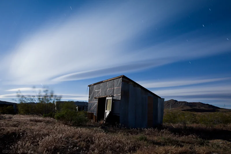 Miner's shack with lenticular clouds, Rand Mining Area -- by Joe Reifer