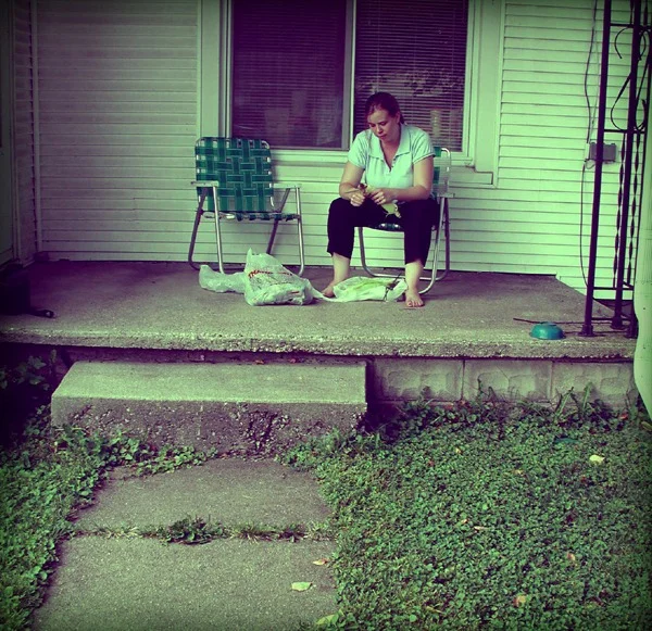 Shucking corn on the porch