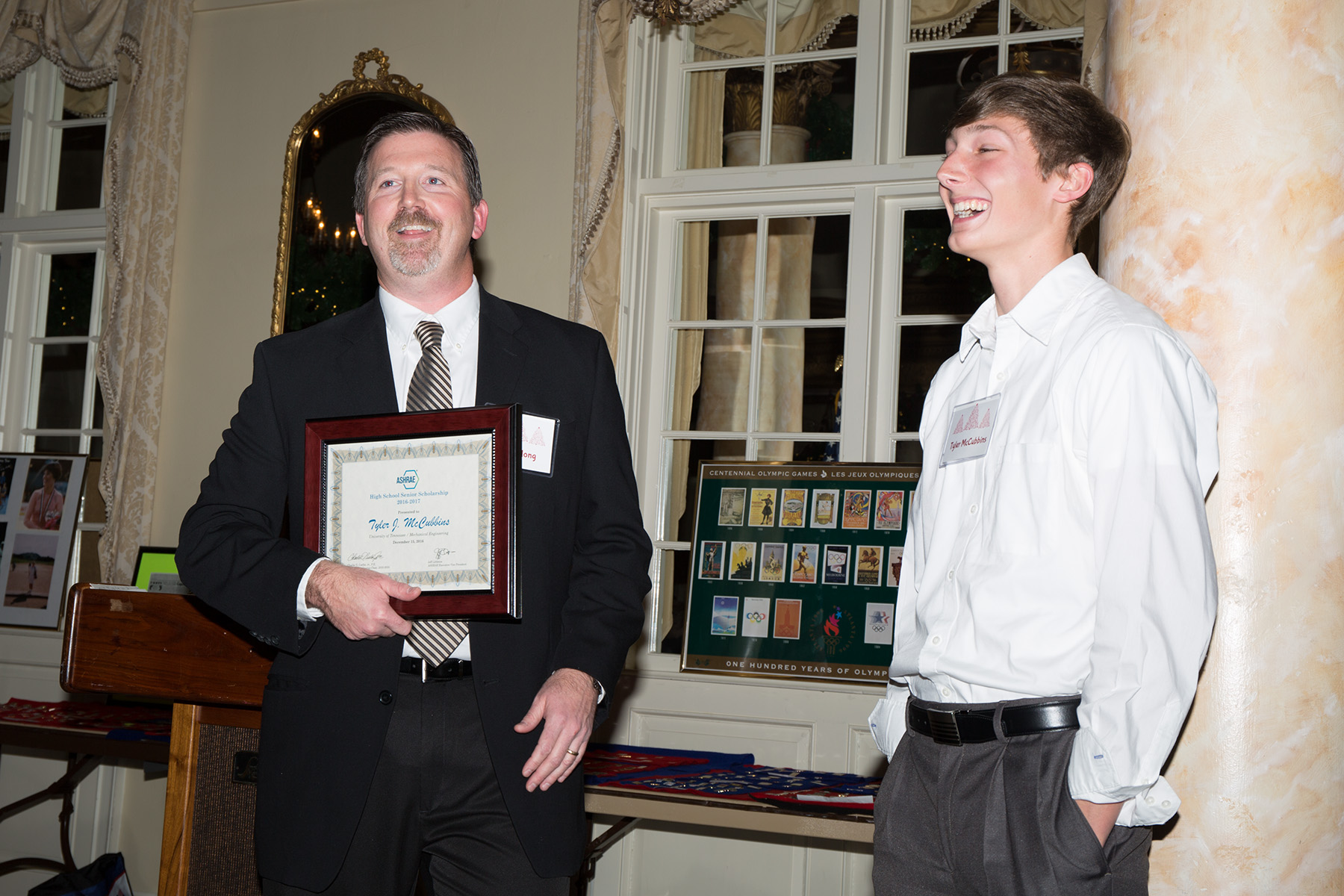  Chapter President Jeff DeLong presents Tyler McCubbins with a certificate recognizing his award of an ASHRAE Scholarship. 