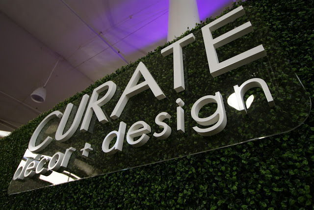 3-D logo mounted against our hedge-wrapped booth
