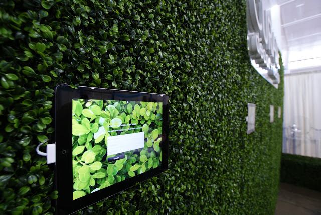 Wall mounted iPads featuring an interactive product gallery and a sign-up form for our giveaway