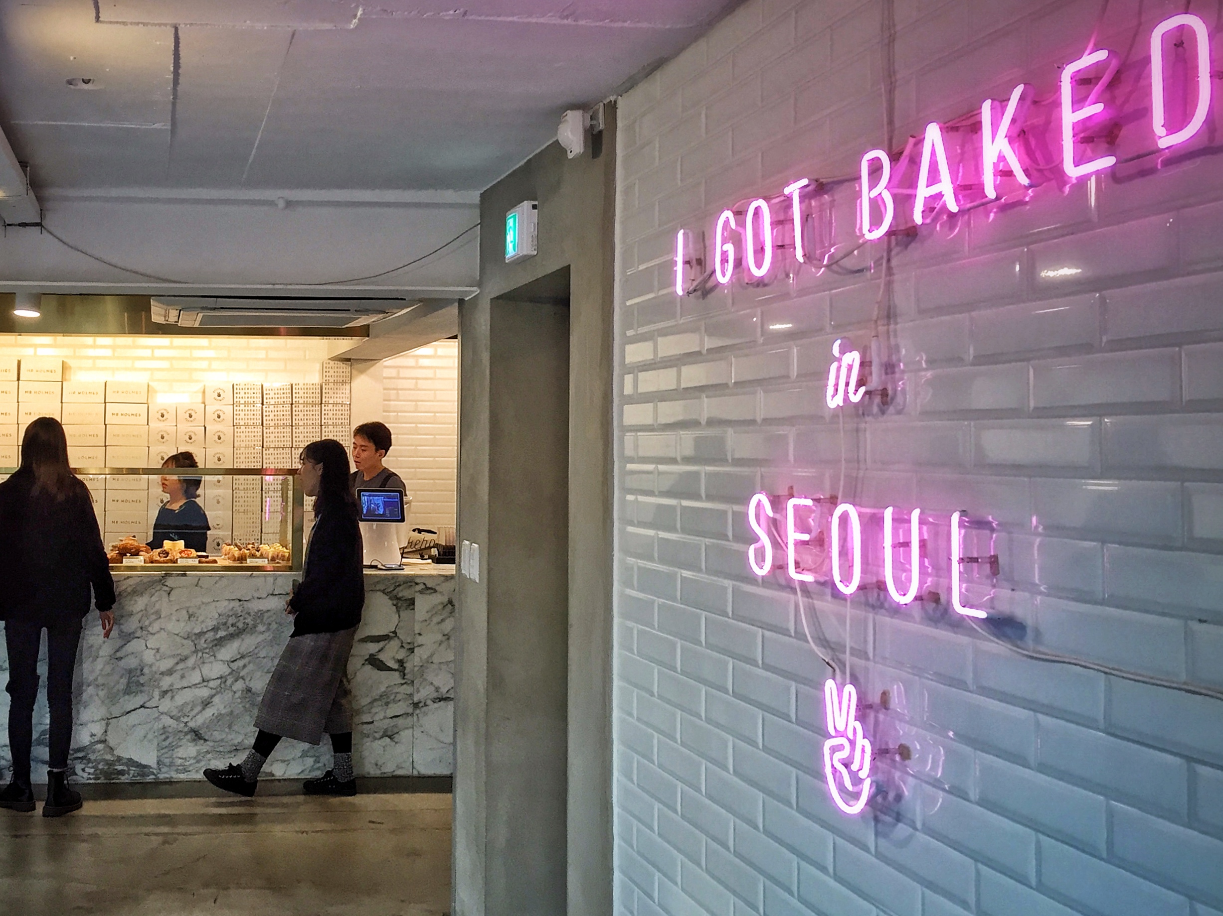 The insta-worthy neon sign provides a sweet modern touch against the classic carrara marble and subway tile. 