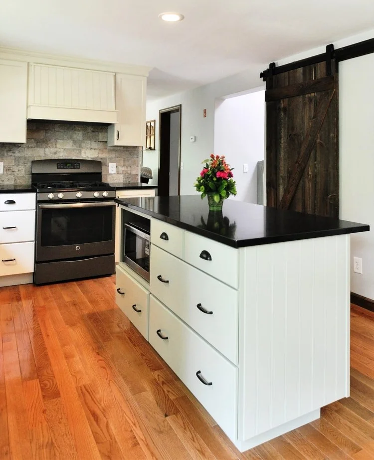 Designed by Erica Smith CMKBD, CAPS / Vantage by Kraftmaid Cabinetry, Full Overlay Grandview Door Style, Maple Wood with Canvas Paint (Willow Paint on Island) / Silestone Tebas Black Quartz Counter Tops
