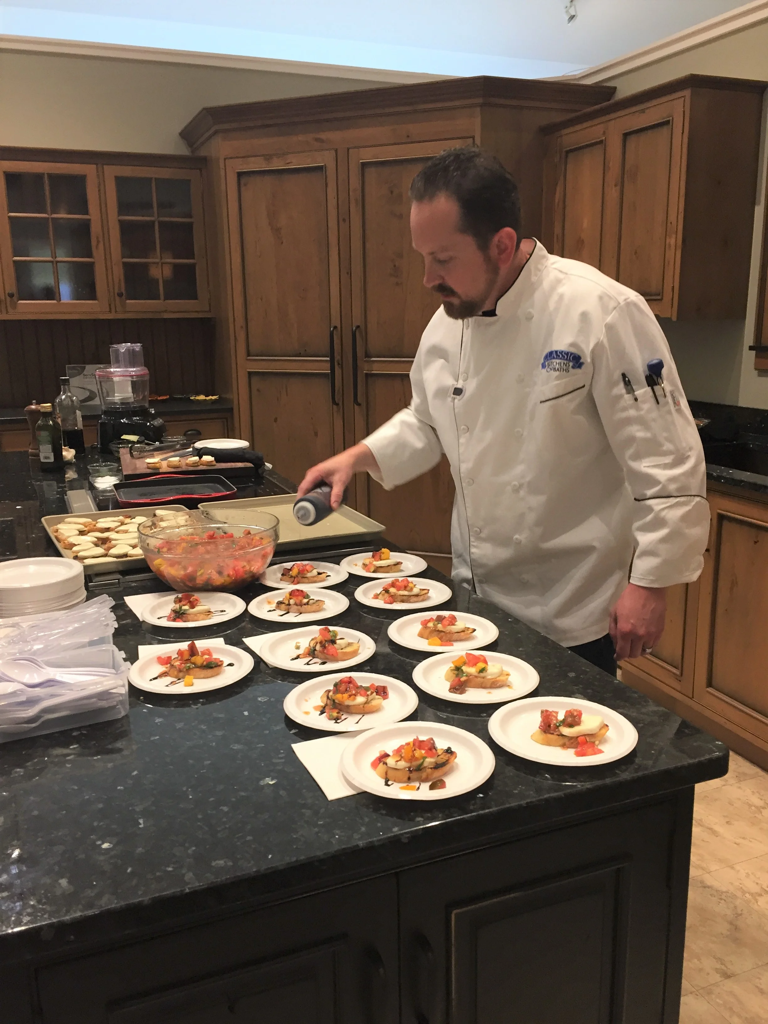Shawn Kelsey preparing appetizers at Classic Kitchens 30th Anniversary Party on 9/30/2017