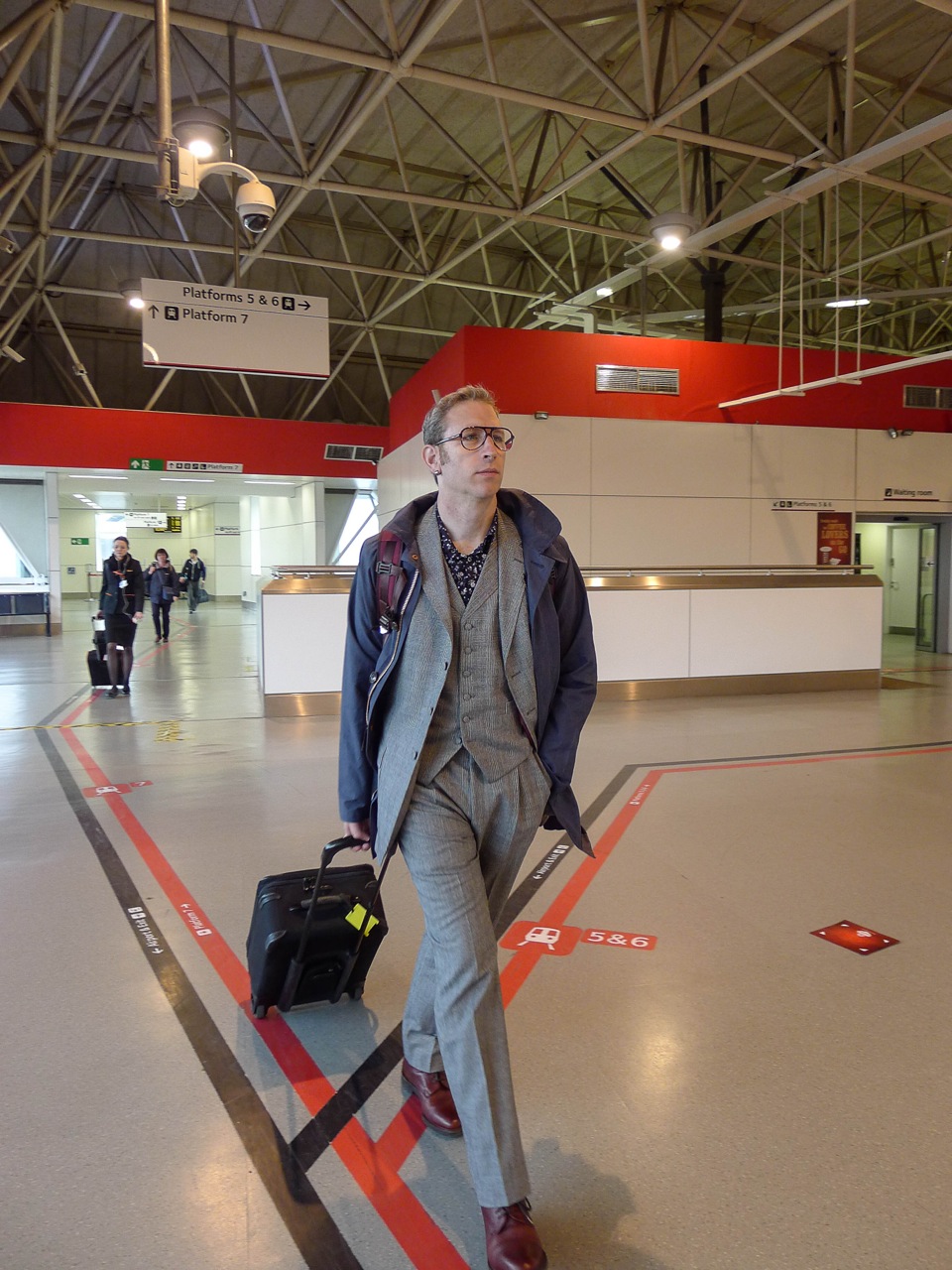 Clean-shaven in a pristine suit at Gatwick airport. May 29th. 