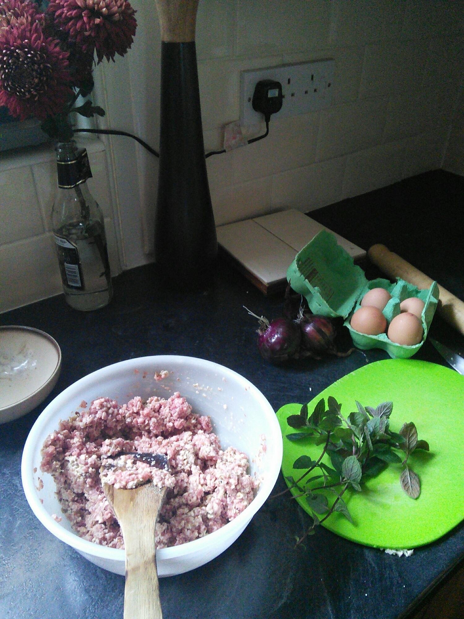 Add mint and an egg to the spices, minced lamb and oatmeal