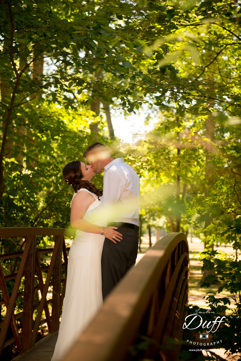  Firefighter Park Wedding - Troy MI wedding photographer. bride and groom kissing on a bridge voyeur.&nbsp; 