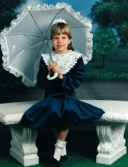 As if the matching frilly umbrella, socks & fake scenery weren't bad enough... 