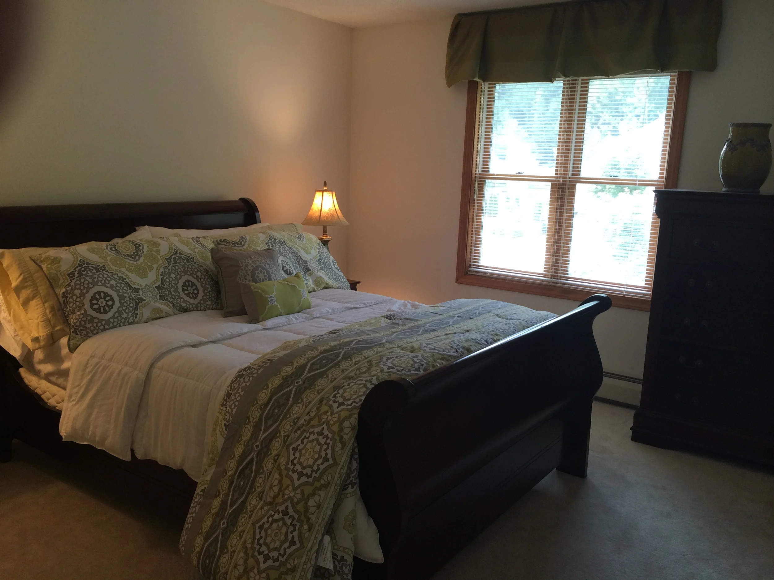 Bedroom with queen sleigh bed on upper floor