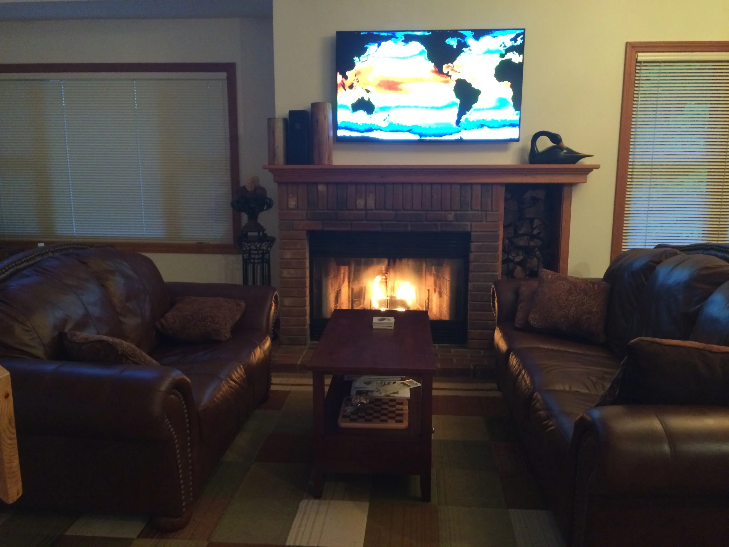 Intimate seating area around fireplace and new 55" flat screen TV
