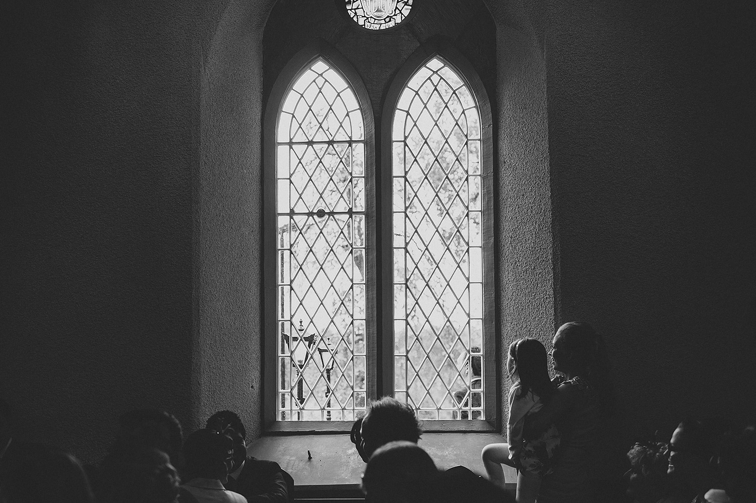 Child looking out church window