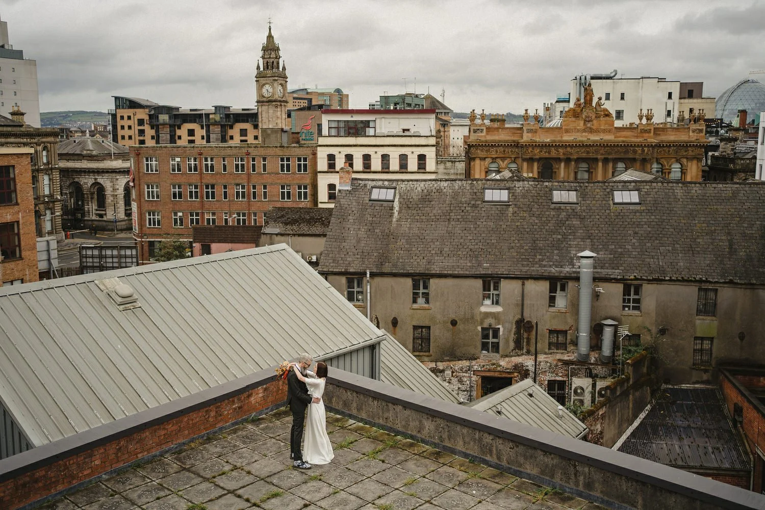 Kathryn and ChrisÕs wedding was supposed to be in Babel rooftop but it burned down 4 days before they were due to get married.  Instead they had their humanist wedding in their own house followed by photos in nearby Ormeau Park and Belfast Cathedral