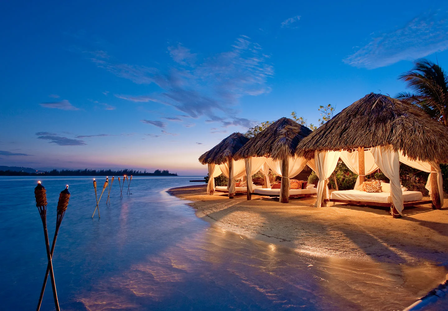 A kaleidoscope of cultures from Britain to Bali awaits you at Sandals Royal Caribbean. The resort's decidedly British heritage begins with the Majestic Georgian-style Great House, surrounded by manicured gardens and roaming peacocks-all complemented with well-heeled traditions like continental breakfast in bed, afternoon tea, and a rousing game of croquet. Minutes away on the resort's private offshore island, the mysteries of the Orient unfold in a secluded natural setting where casual poolside and beachside pleasures beckon by day, while chic parties, an authentic Thai restaurant, and island-style extravaganzas invite excitement by night. At Jamaica's most alluring resort, two diverse vacations are woven into one and served with warm island hospitality, making your stay a journey to remember.