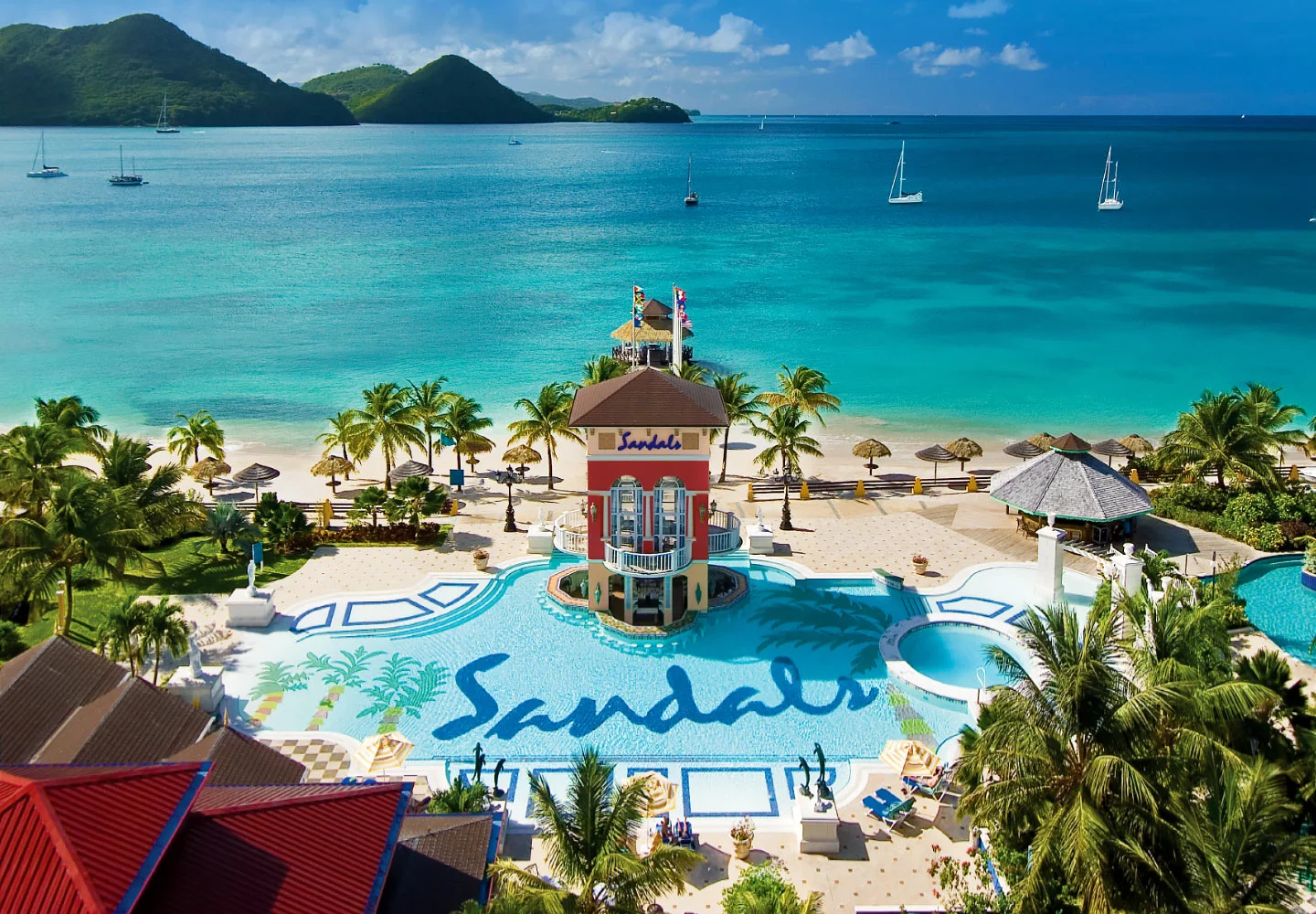 Ideally located on its very own peninsula, Sandals Grande St. Lucian is often described as the "closest vacation to a picture-perfect postcard." Cradled to the west by Rodney Bay - boasting the calmest waters in all of Saint Lucia - and to the east by the majestic Atlantic Ocean, this magnificent resort showcases awe-inspiring panoramic views that will linger in your heart forever. Volcanic mountains draped in blankets of green rise majestically from an impossibly clear blue sea. A sheltered mile-long beach extends an open invitation for days of endless water play. This is paradise as it was meant to be, full of natural beauty, rich in history, and resplendent in pure romance.