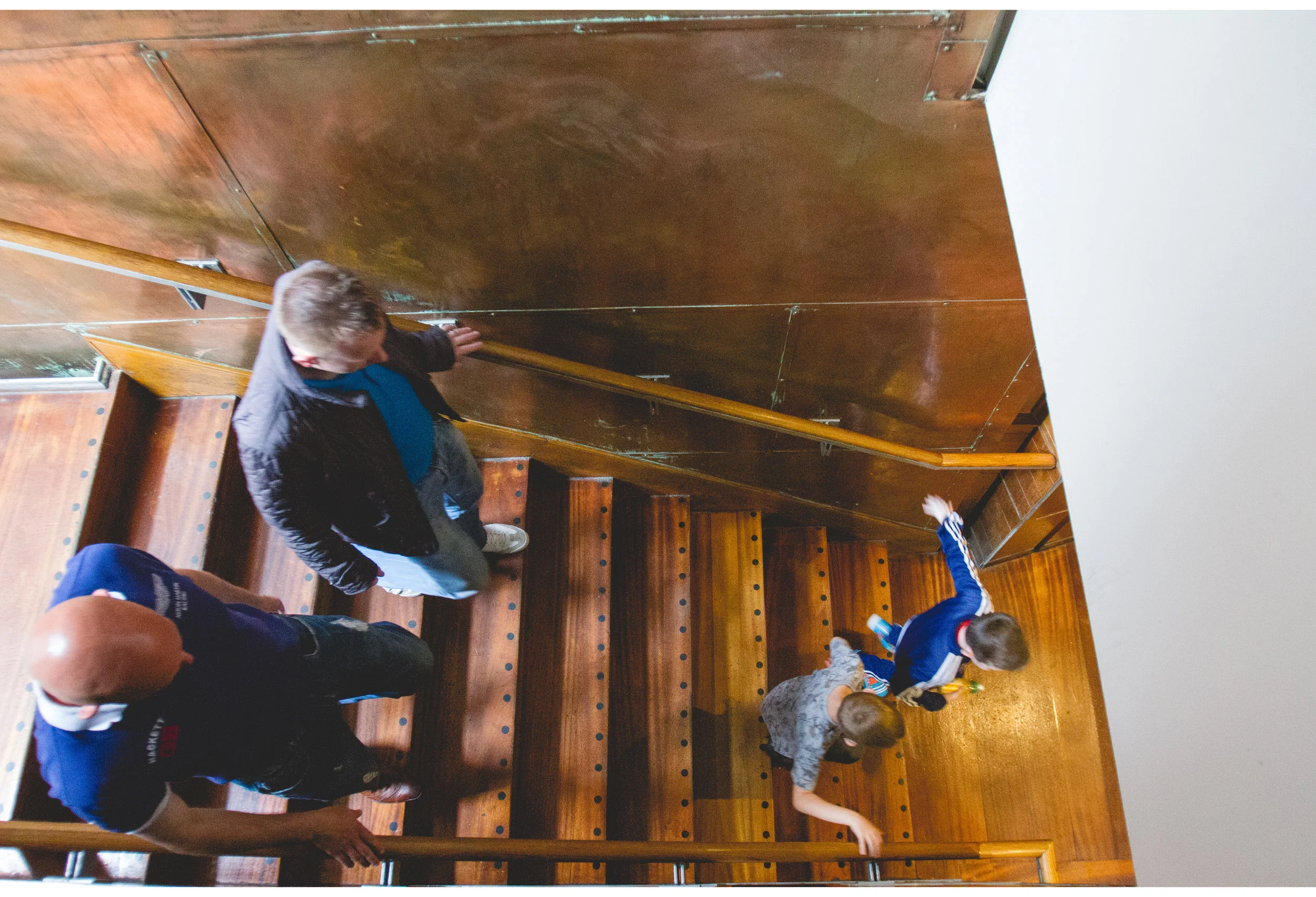 kids running down stairs after wedding breakfast