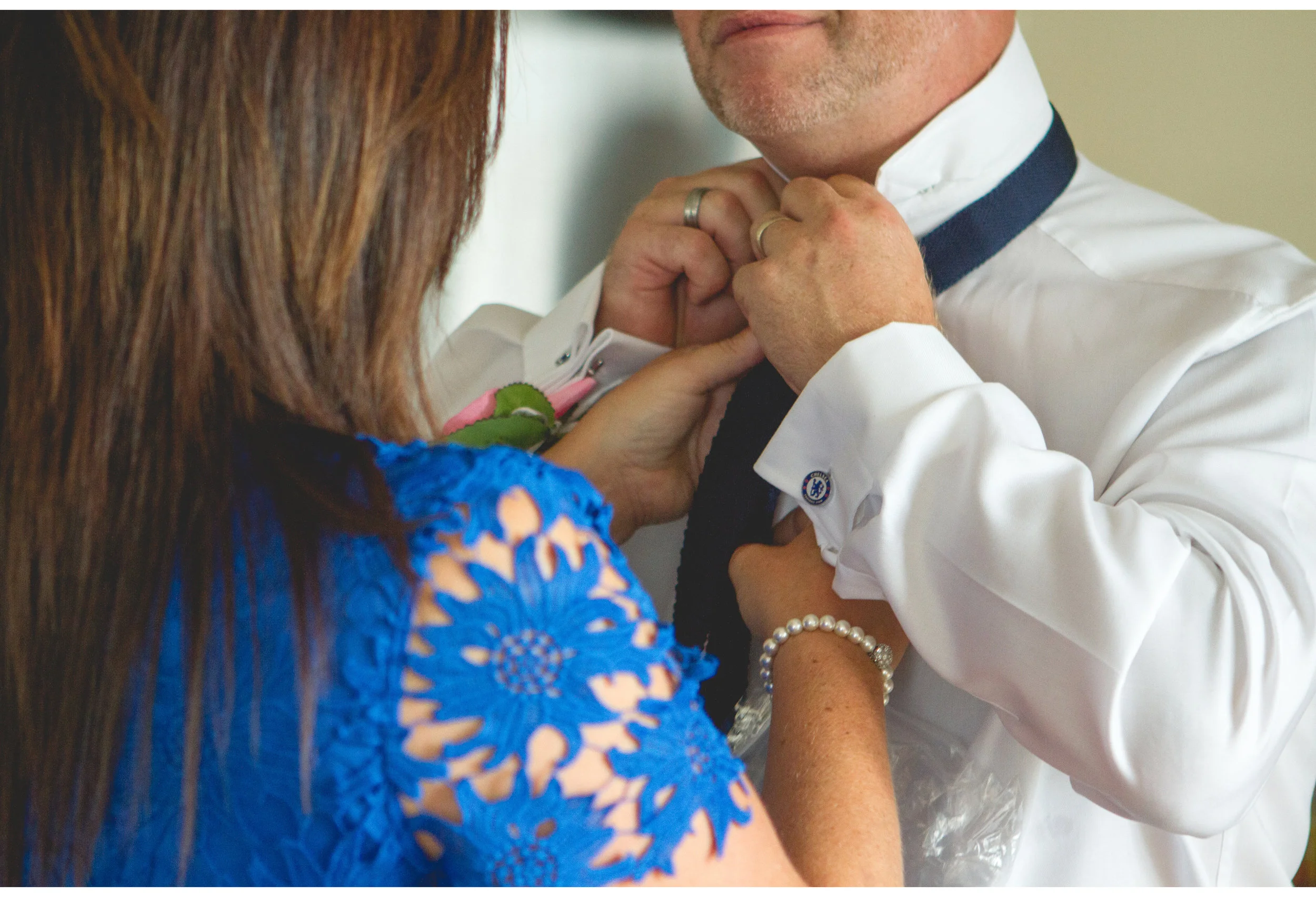 groomsman getting help doing tie up in Liverpool  