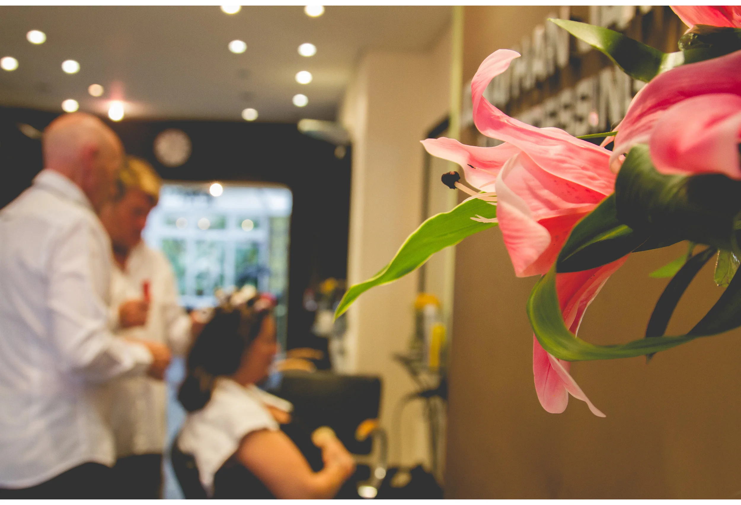 lily flowers with bride getting hair done