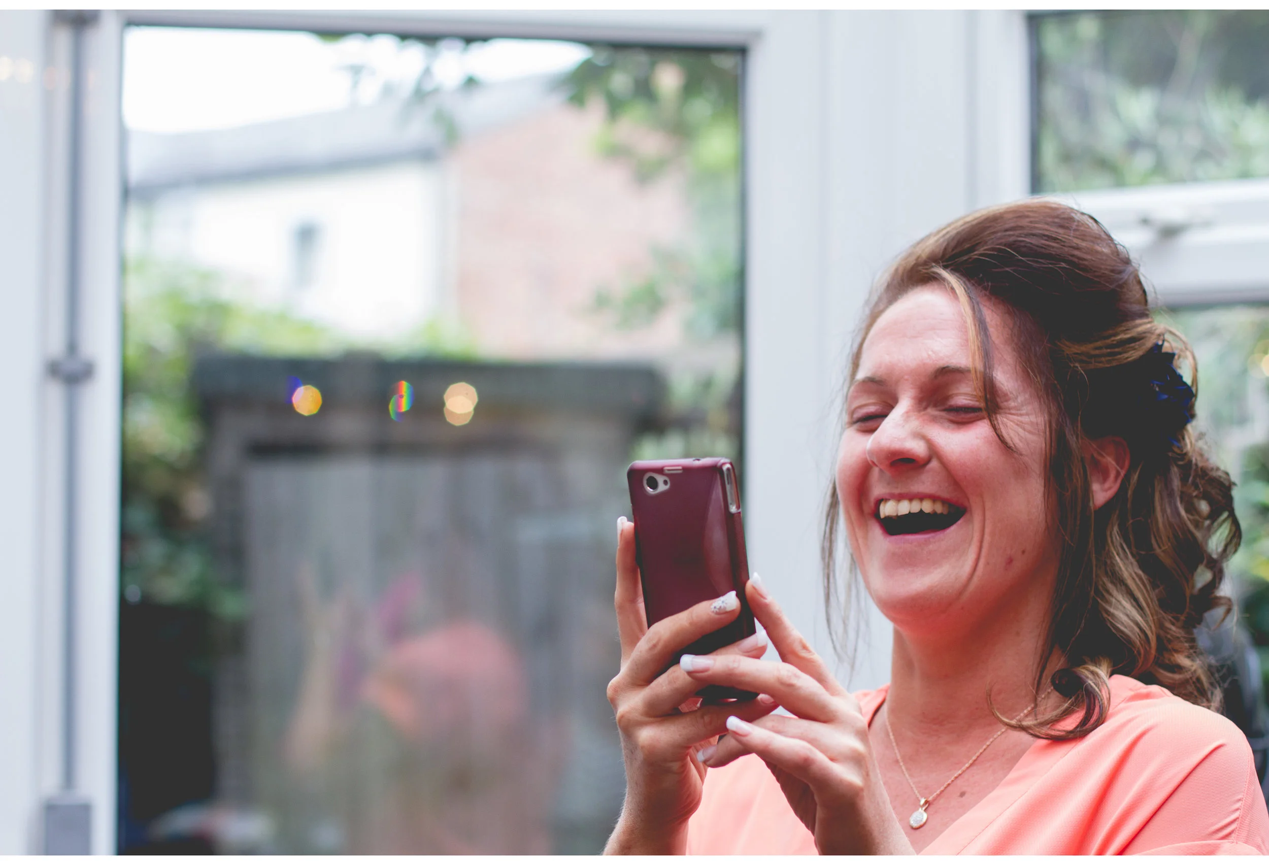 happy bridesmaid laughing in crosby makeup studio