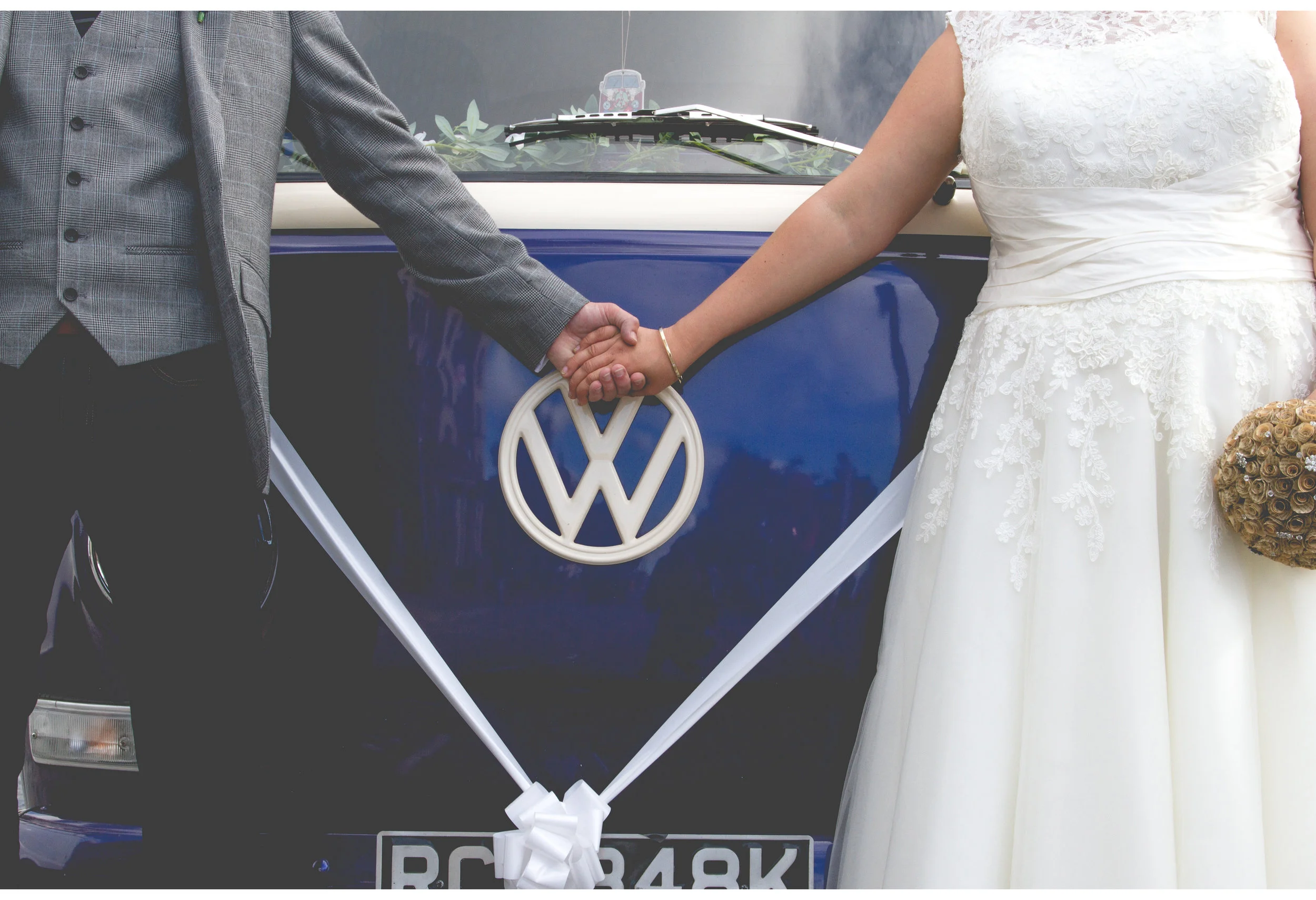 Vw bus wedding car bride and groom holding hands