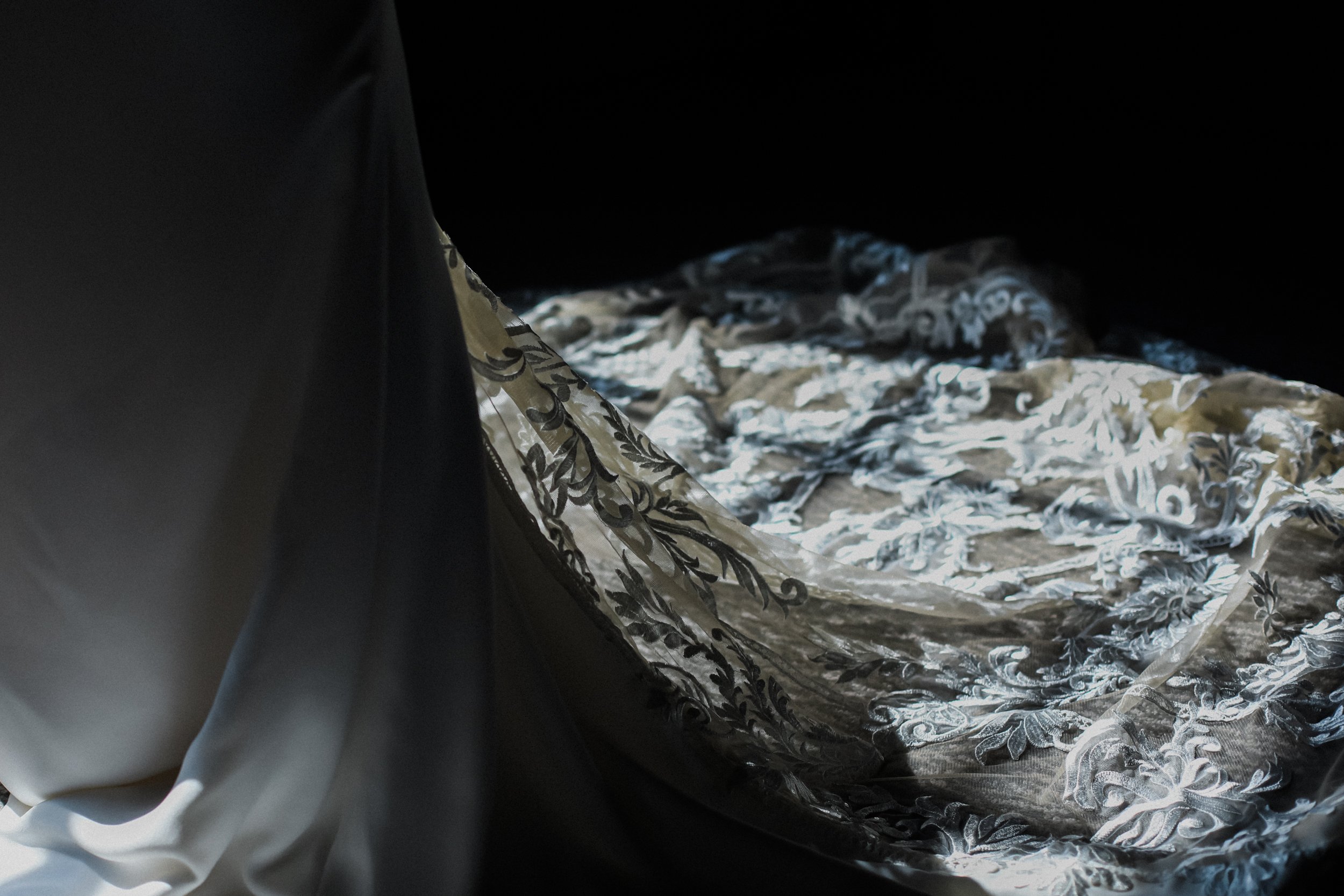 Veil's Radiance: Delicate Veil Detail Bathed in Sunlight, Revealing Its Sheer Beauty and Adding a Heavenly Aura to the Bride's Ensemble.