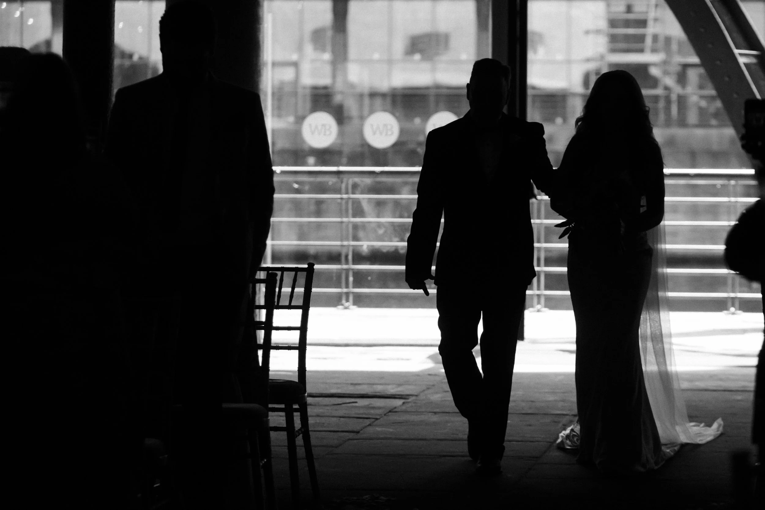 Sentimental Journey: Silhouette of the Bride and Father of the Bride Walking Down the Aisle at Titanic Hotel, Capturing a Touching and Memorable Moment.