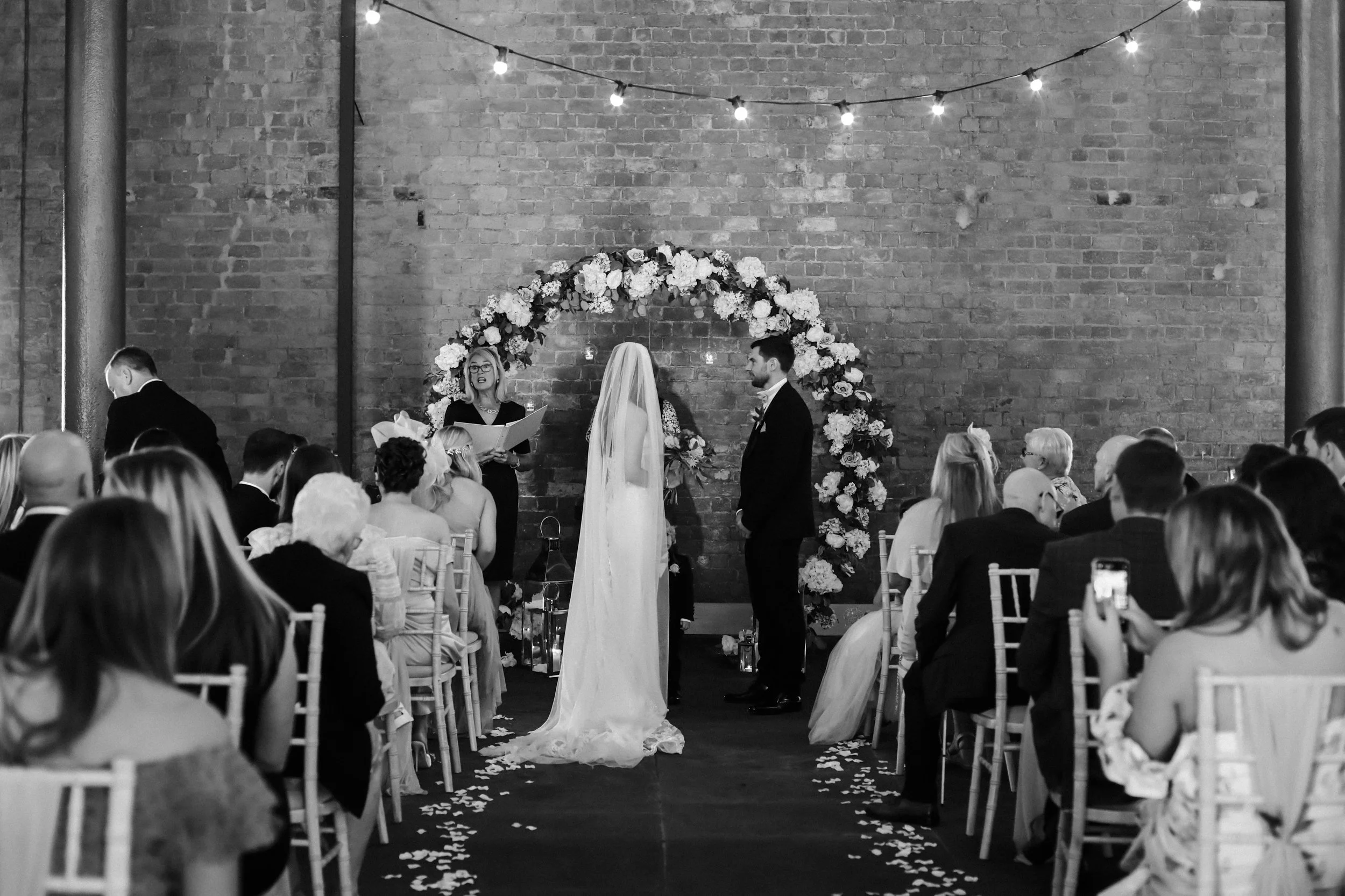 Unforgettable Vows: Bride and Groom Stand Together at the Ceremony, Exchanging Their Promises at Titanic Hotel, a Moment That Marks the Beginning of Their Journey Together.