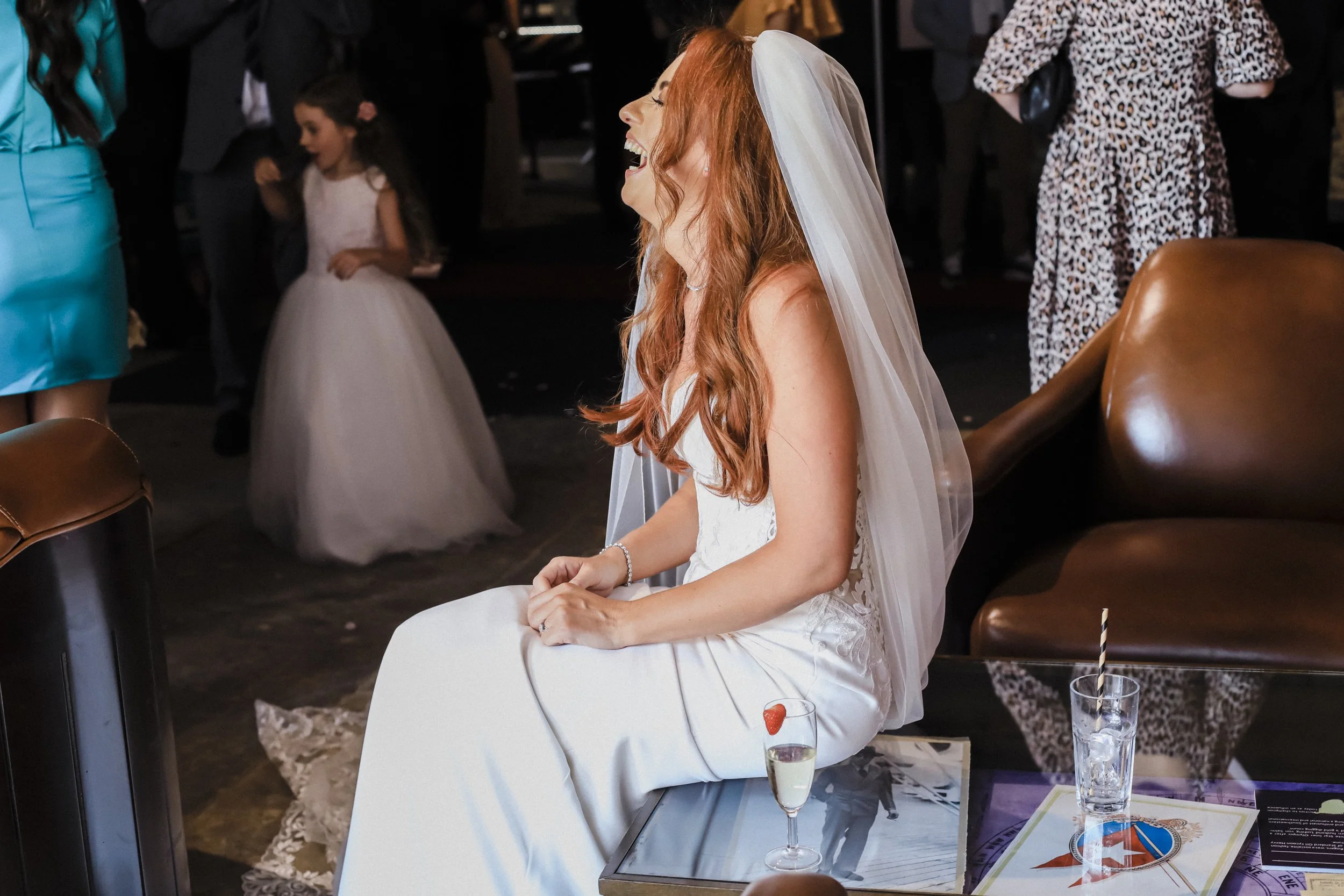 Infectious Joy: Bride Radiates Laughter at Titanic Hotel, Filling the Atmosphere with Her Happiness and Adding a Touch of Lightheartedness to the Celebration