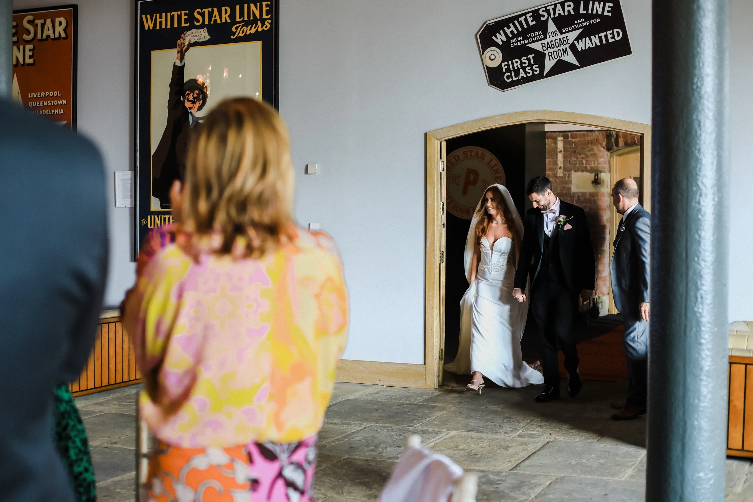  Bride and Groom Are Announced In for Their Wedding Breakfast at Titanic Hotel Liverpool, Greeted with Applause and Cheers from Their Guests, Marking the Start of a Memorable Celebration
