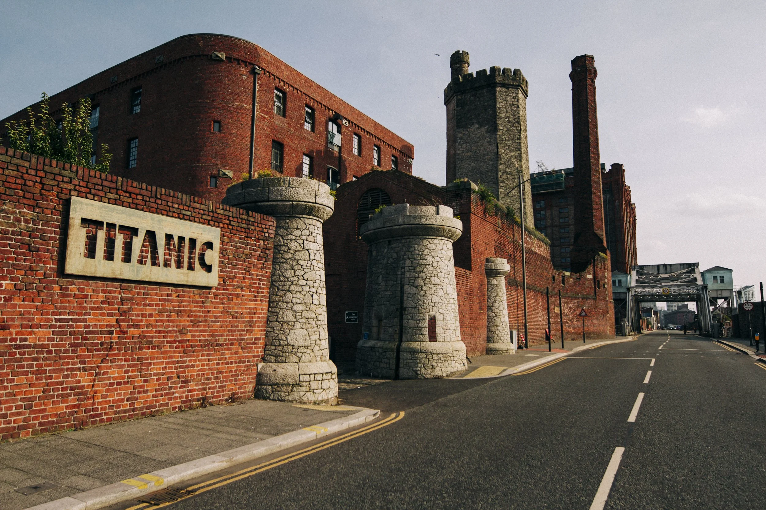 Golden Hour Elegance: Titanic Hotel Sign with the Building and Stanley Dock Bathed in the Warm Glow of Sunlight During the Golden Hour, Creating a Beautiful and Serene Scene.