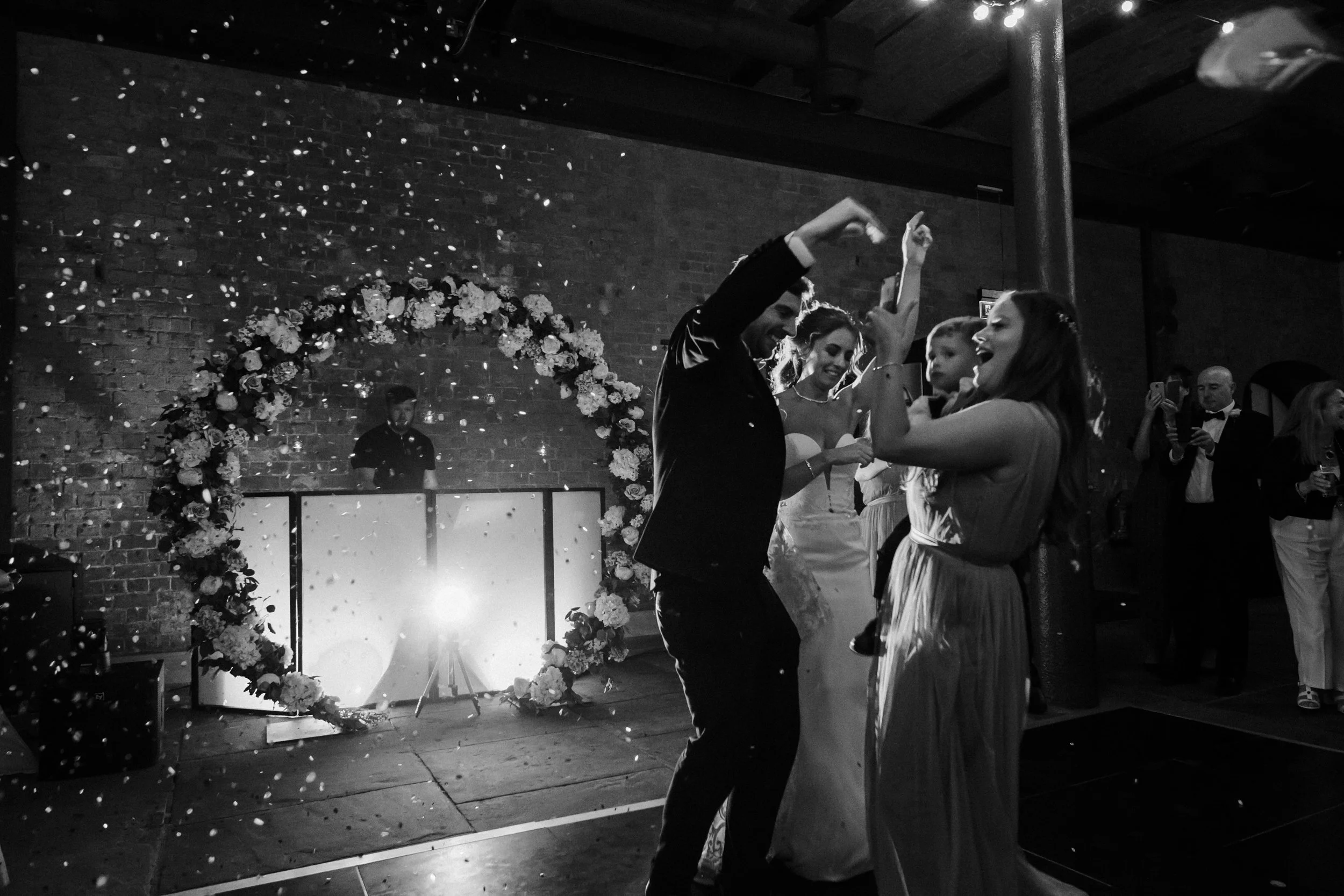 Party Beginnings: Brides and Groom Conclude Their First Dance with a Shower of Confetti, Igniting the Celebration at Titanic Hotel Wedding in Liverpool.