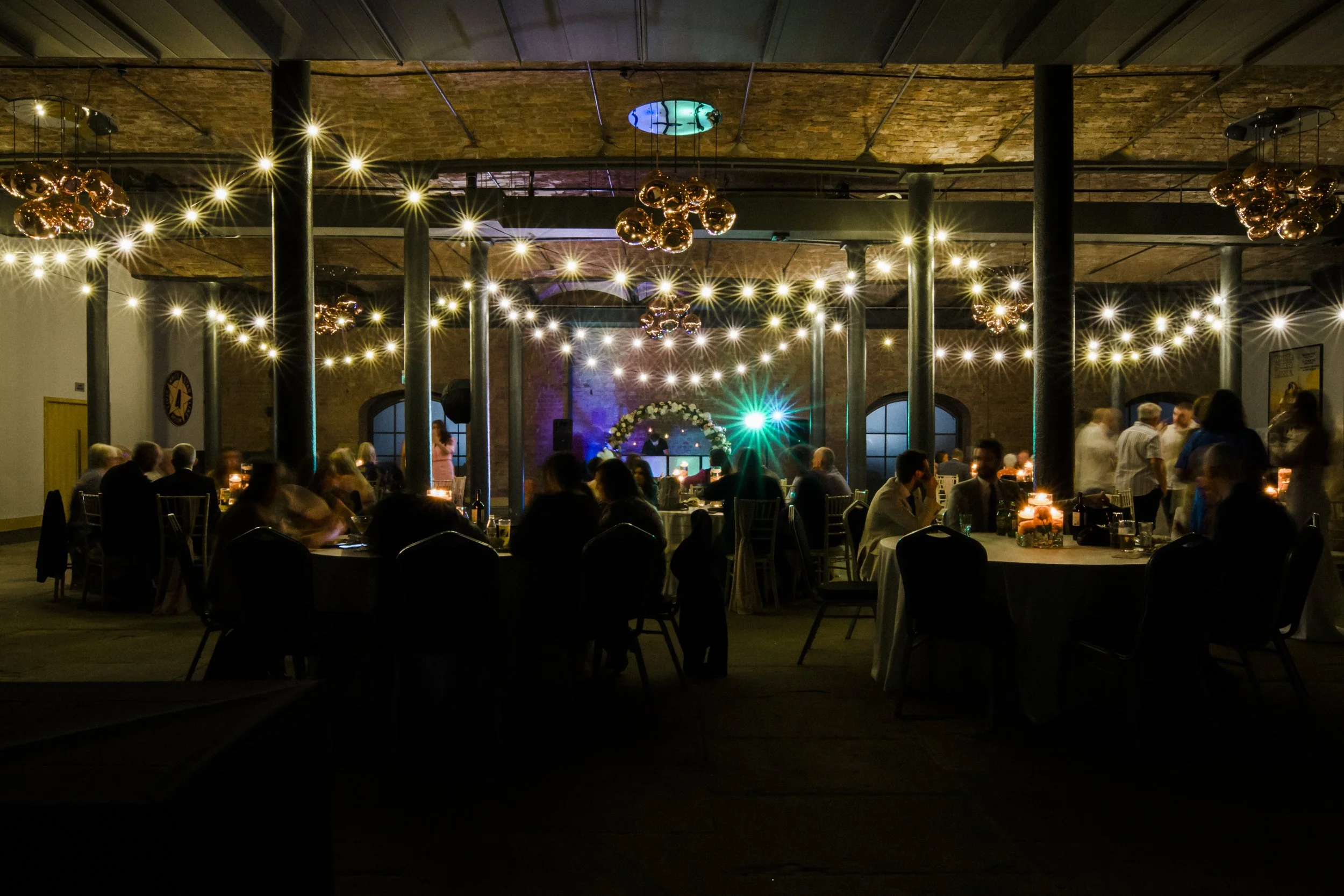 Vibrant Celebration: The Titanic Hotel Liverpool Wedding Party Radiates Joy and Energetic Atmosphere from the Outside, Marking the Start of a Night Filled with Fun and Festivities.